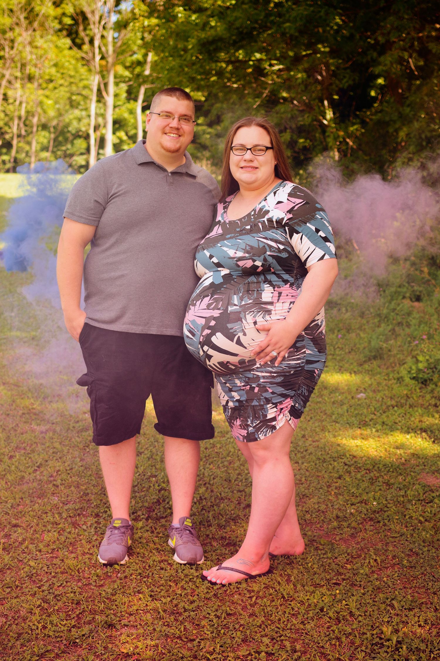 Purple smoke adds atmosphere to an outdoor photoshoot on grass.