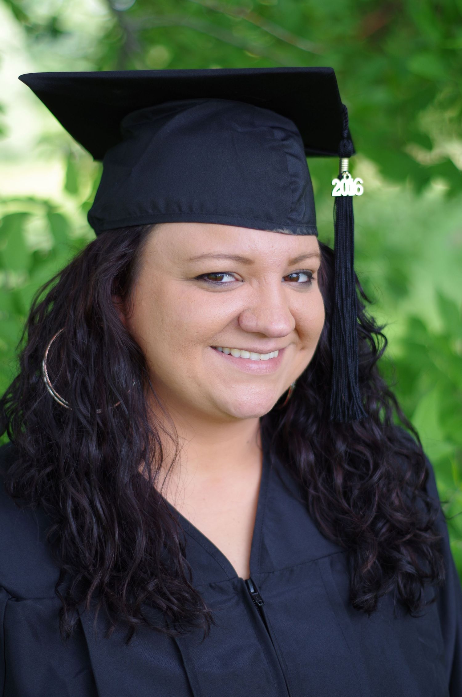 Candid graduation portraits captured outdoors with natural lighting and greenery.