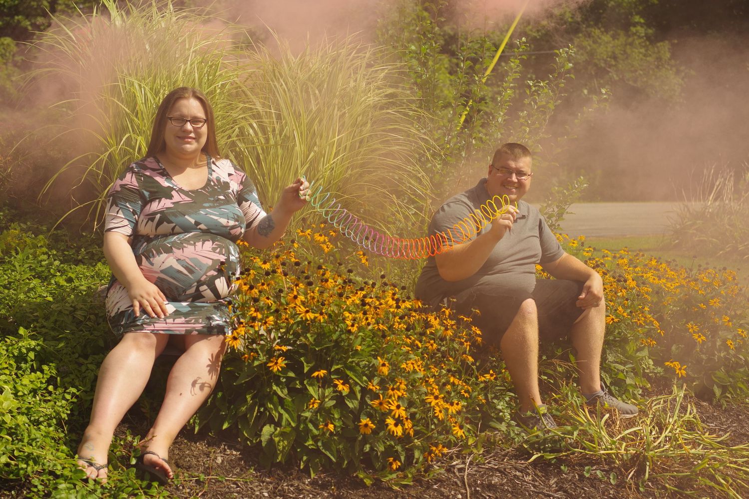 Smoke effects and wildflowers create atmosphere in an outdoor photo setting.