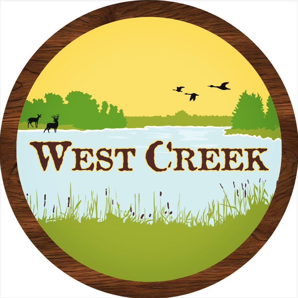 Round wooden framed logo showing nature scene with deer and birds at sunset.