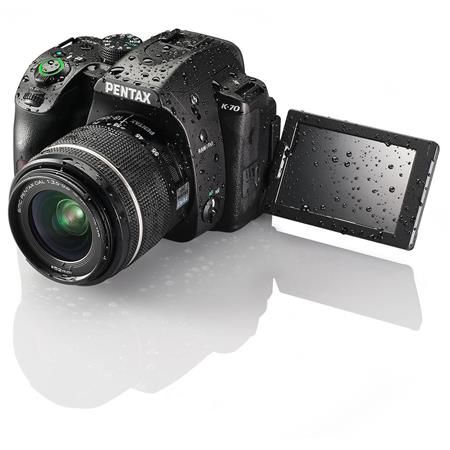 Pentax DSLR camera with articulating screen display showing water droplets.
