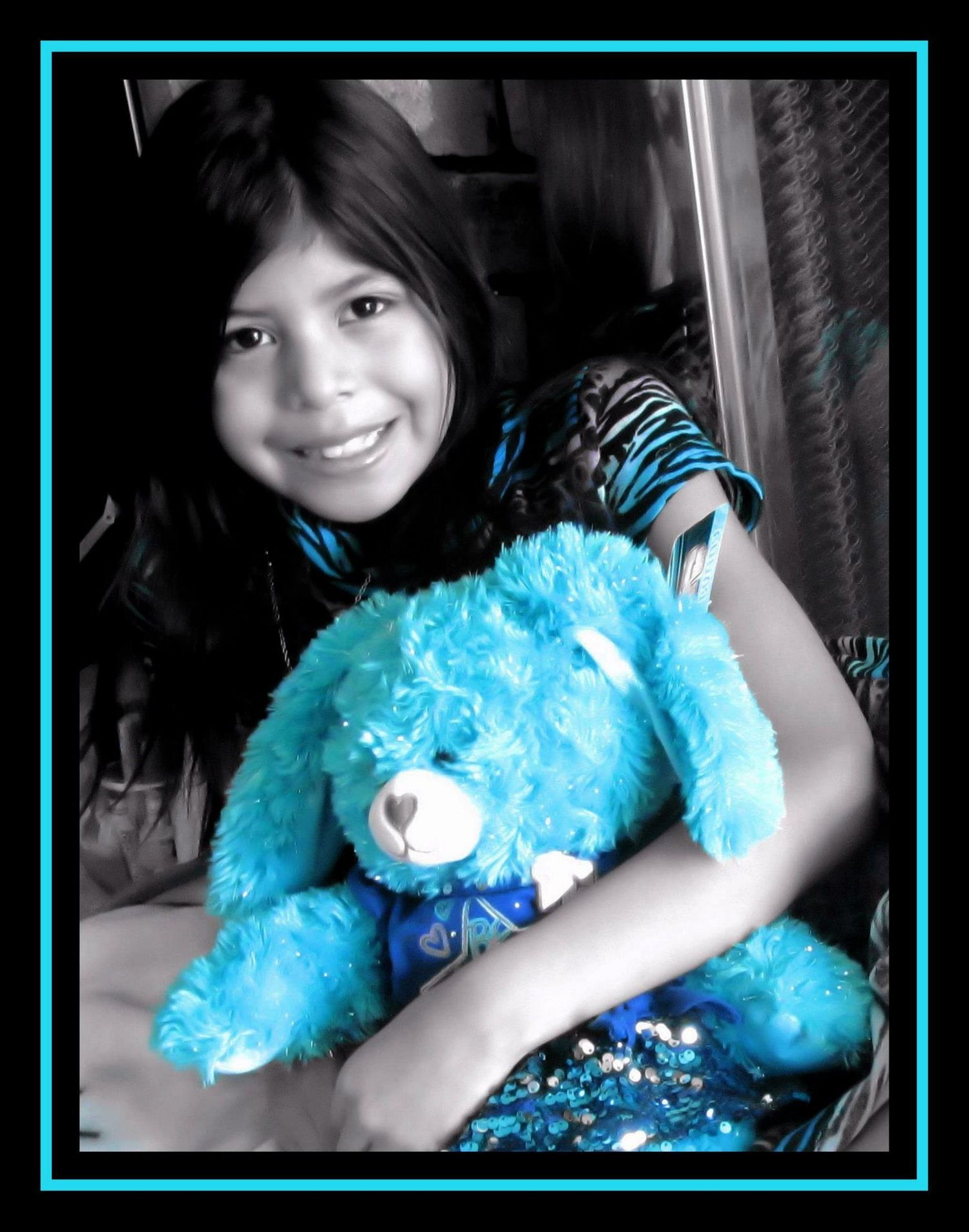 A person holds a bright blue teddy bear in a black and white photo with blue accents.