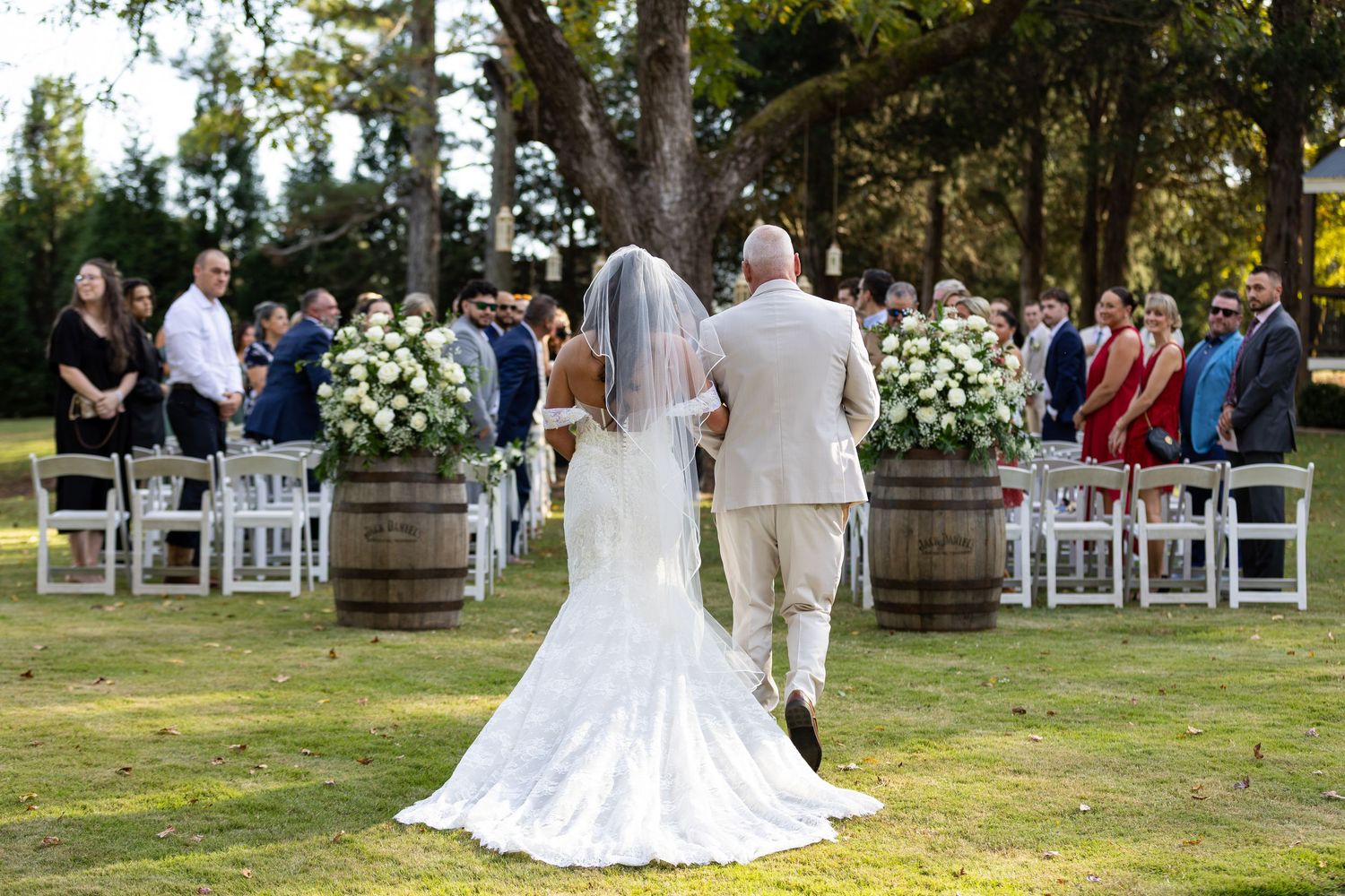 A bride and her father walk down the aisle during an outdoor wedding in Northeast Georgia.