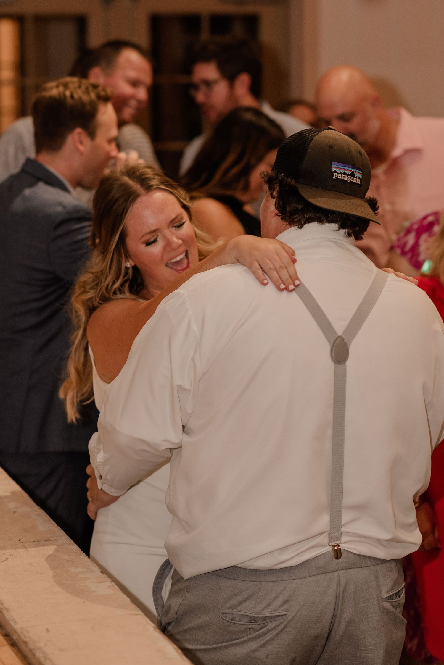 Intimate moment shared between guests during wedding reception celebration.