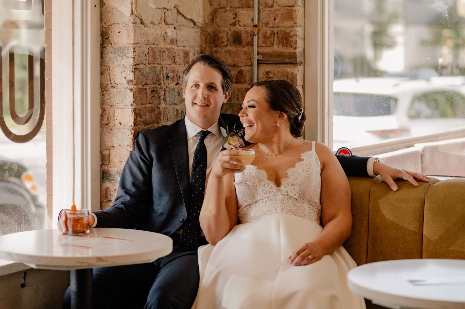 Wedding couple enjoying celebratory drinks in a quaint Bishop Arts bar in Dallas, TX