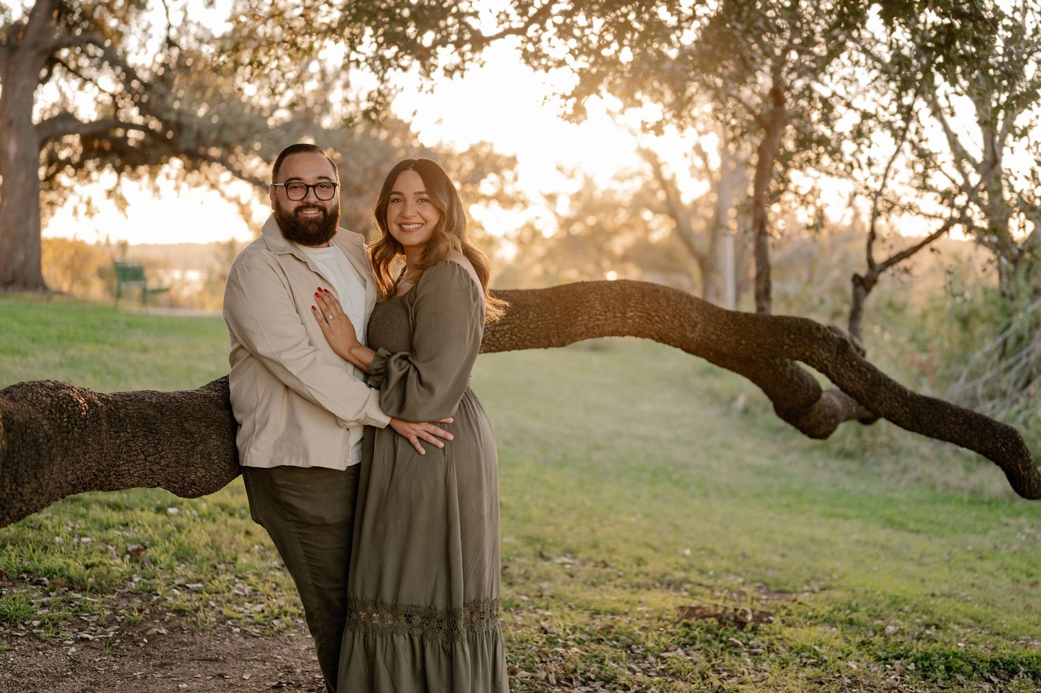 Posed photo of married couple in front of a beautiful tree at sunset overlooking the White Rock Lake in East Dallas, Texas