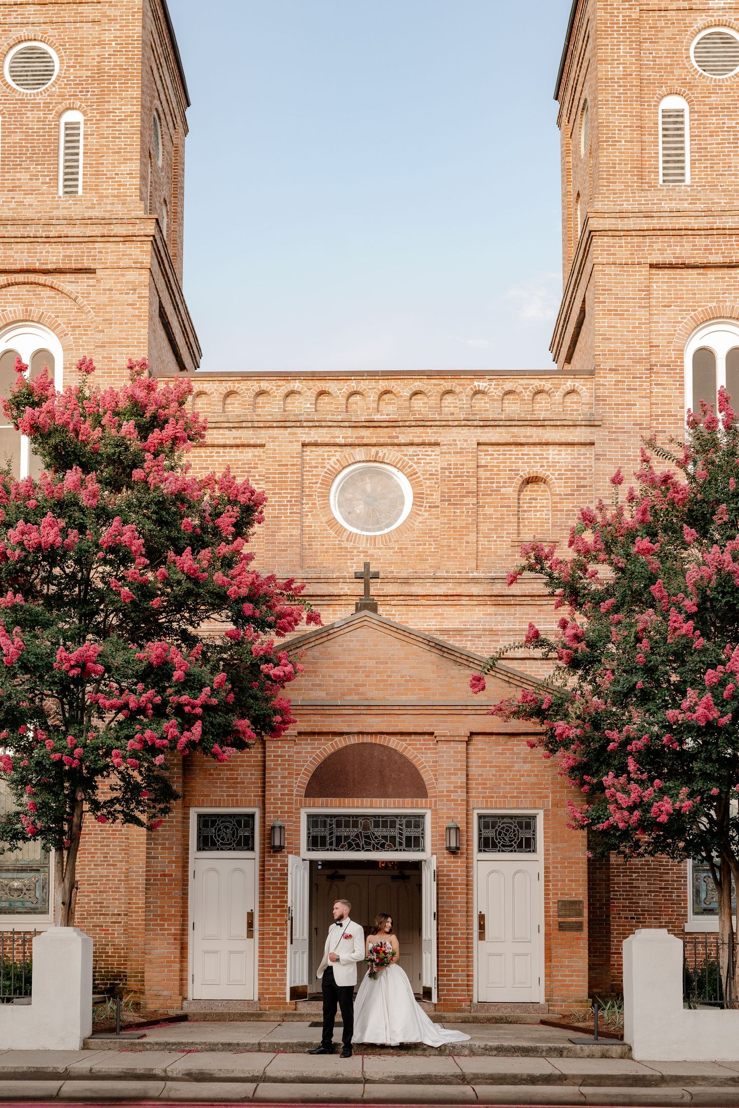 Bride and Groom posed outside of Catholic Church venue in Natchitoches, Louisiana for wedding couple portraits.