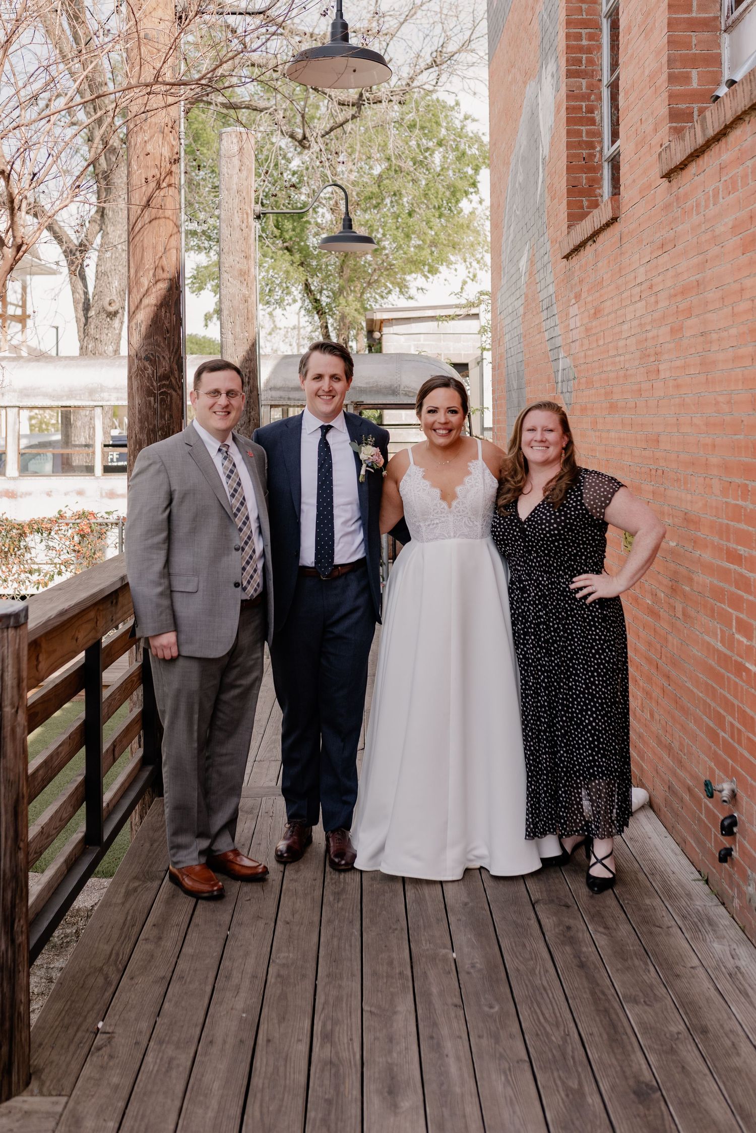 Wedding couple and friends pose together outside of Bishop Arts area in Dallas, Texas