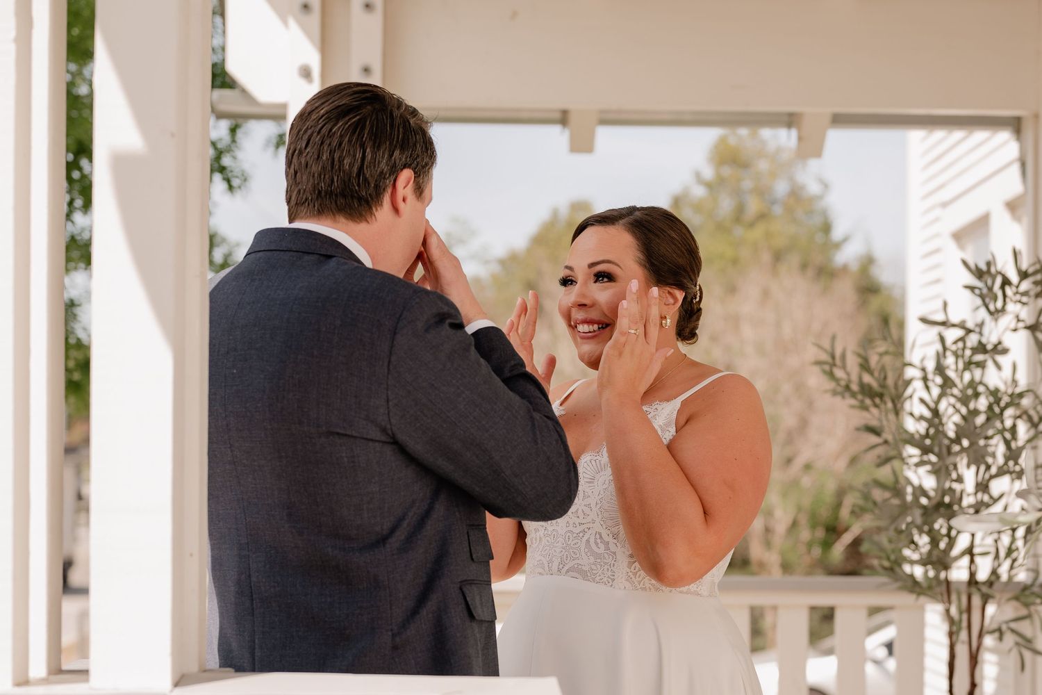Genuine laughter and emotion during a first look moment between bride and groom outdoors for their Spring wedding