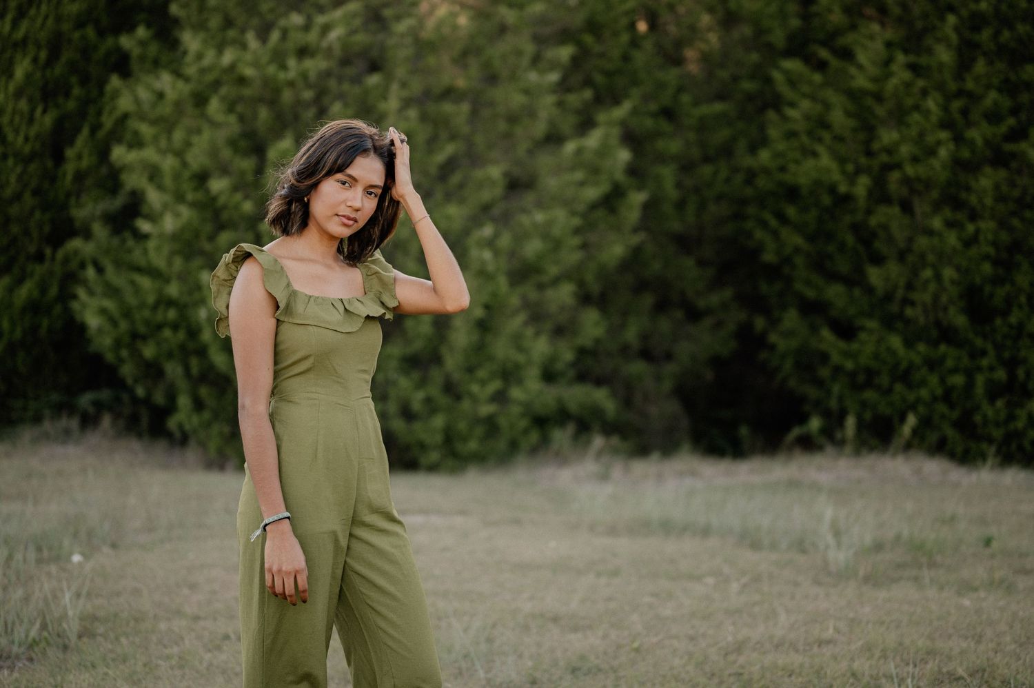 Candid portrait of a girl in a large field lined with trees in Sunnyvale, Texas