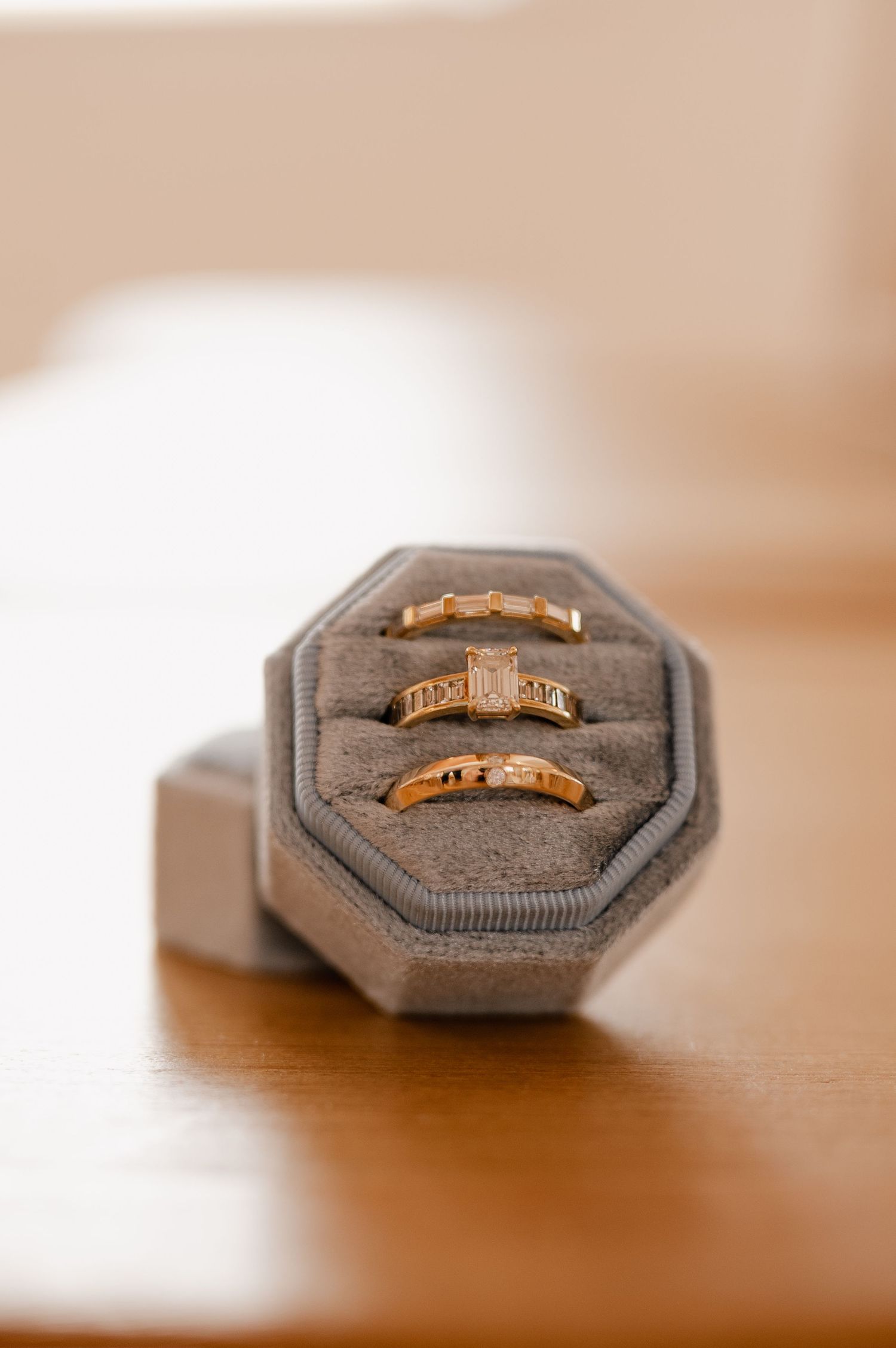 Two gold wedding rings displayed in a blue octagonal ring box