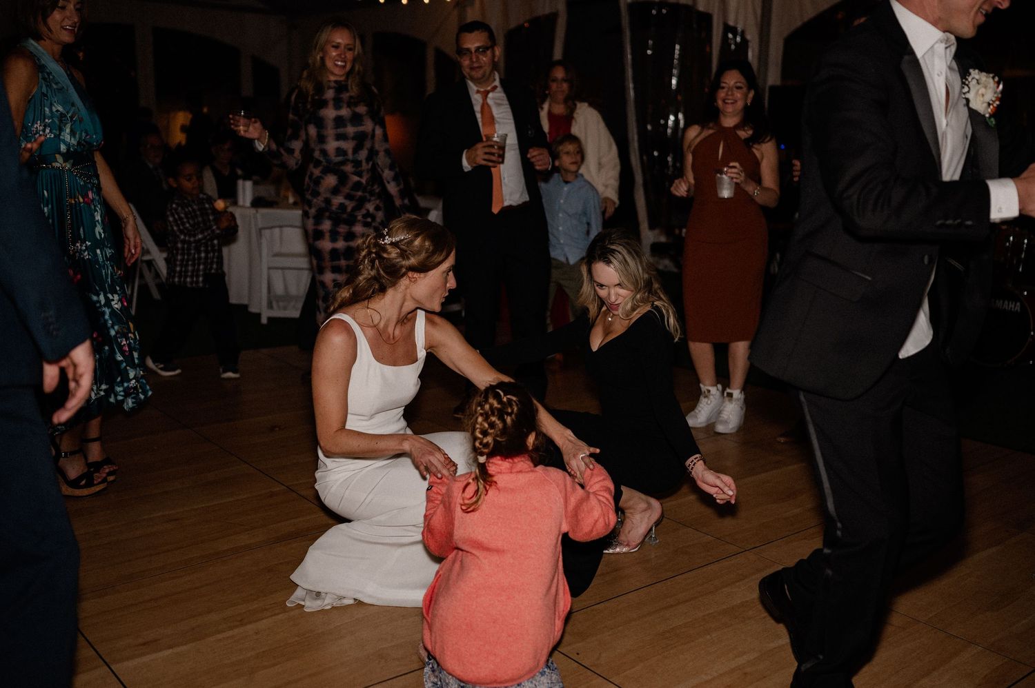 Documentary style candid of bride and guests dancing at energetic wedding reception in the Berkshires Massachusetts