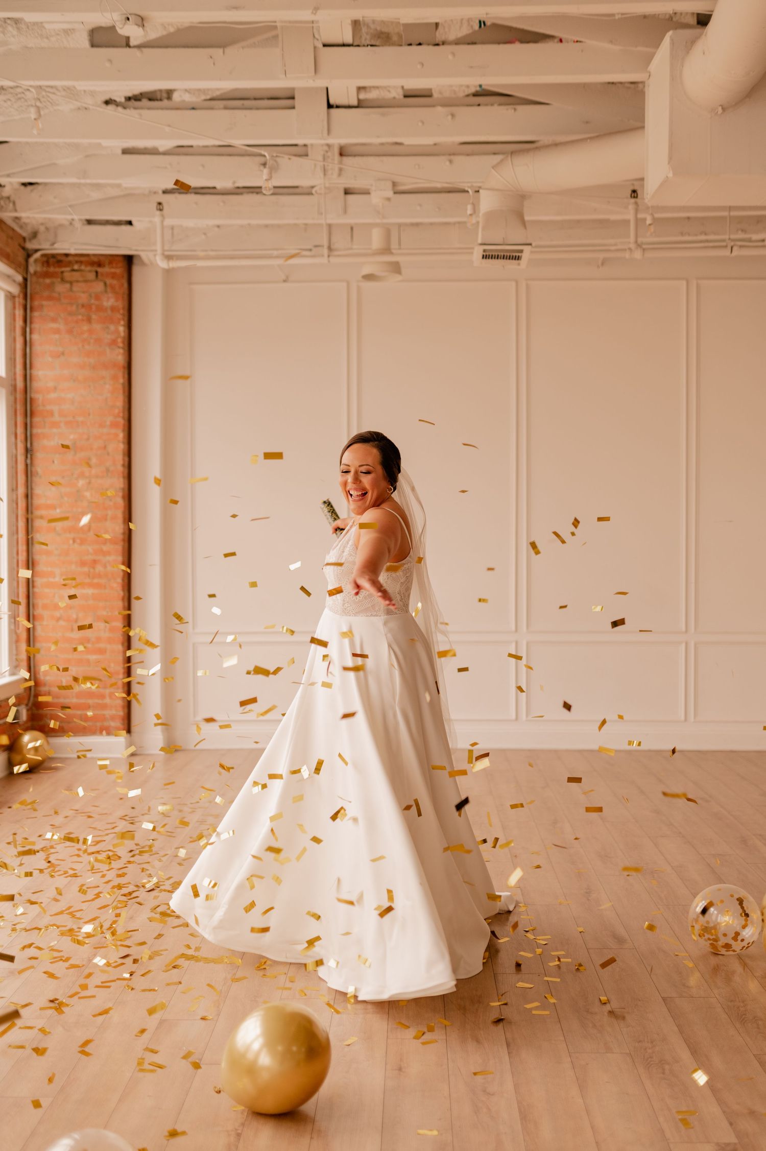 Sequence of joyful spins in a white gown with gold confetti and a decorative ball on wooden floor.