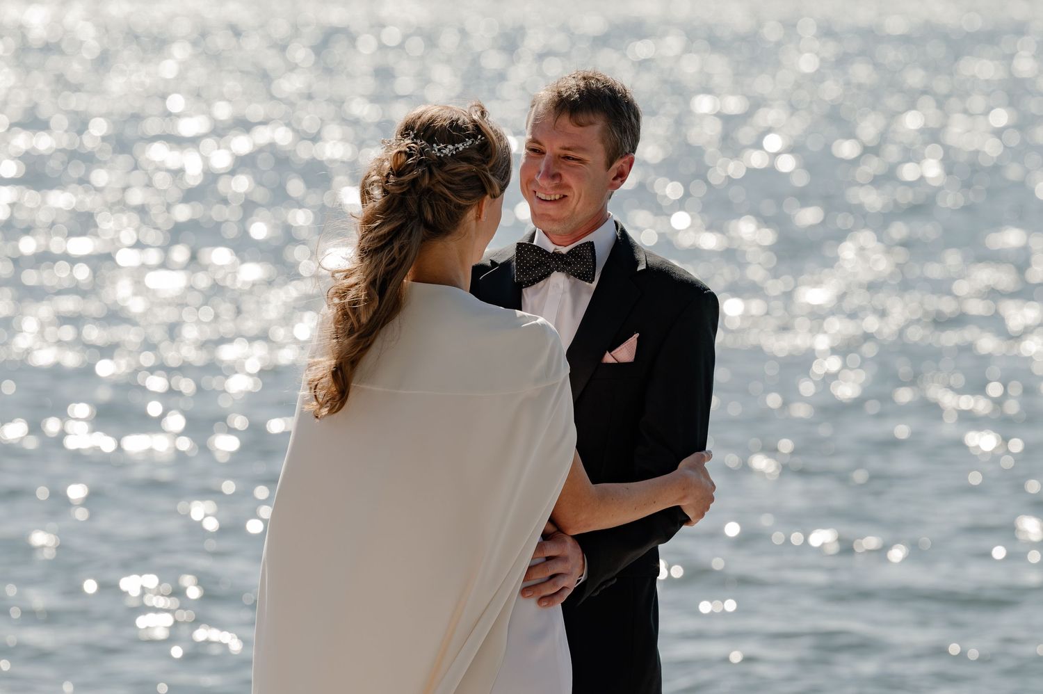 Documentary style candid of a bride and groom during the wedding first-look over looking the lake in the Berkshires Massachusetts