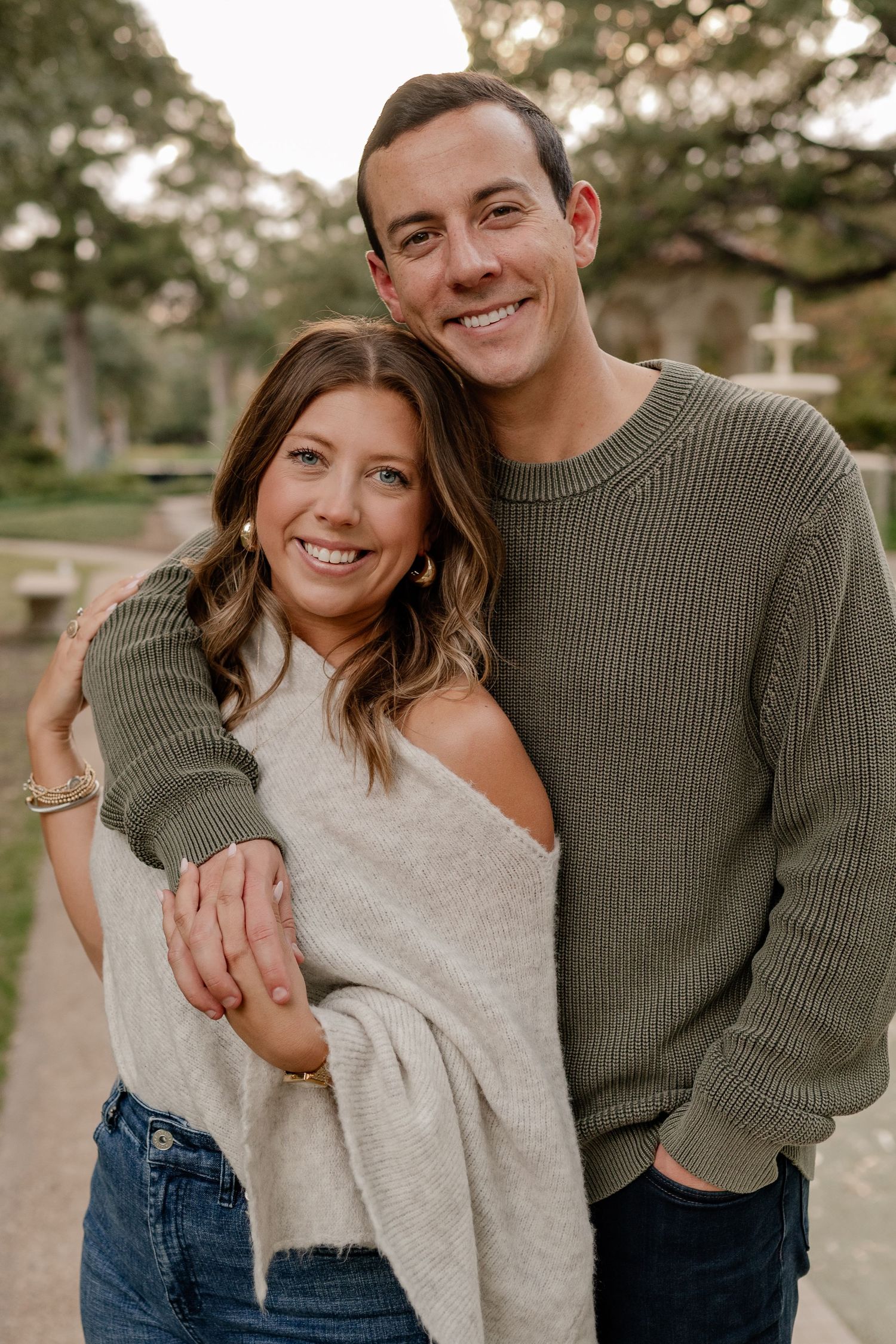 Couple standing in front of a water feature at Flippen Park in Dallas for their fall couple's photo session