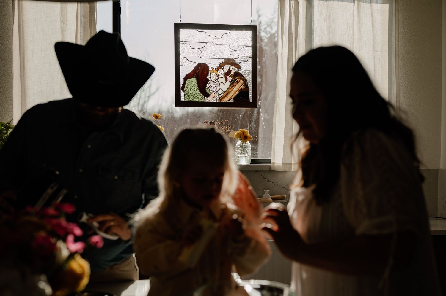 Candid silhouette image of a family baking in their kitchen for an at-home family session in Greenville, Texas