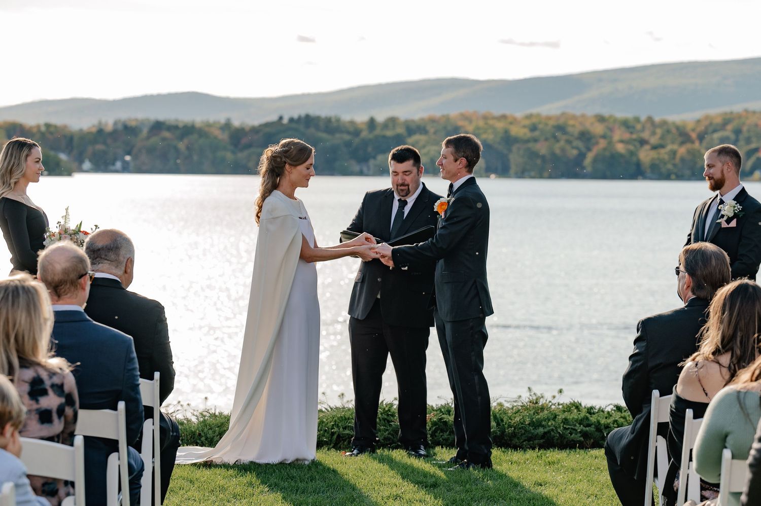 Documentary style candid of a bride and groom at the wedding ceremony over looking mountains and lake in the Berkshires Massachusetts