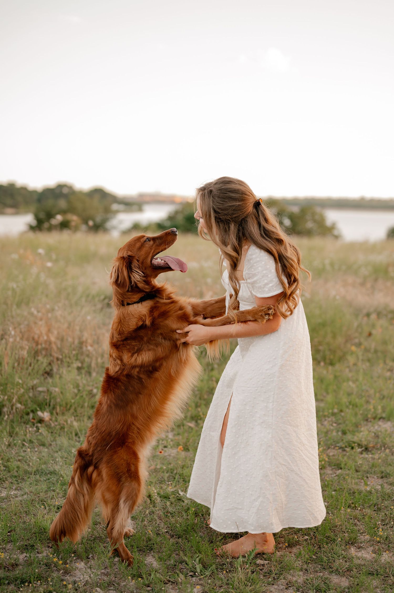 Candid lifestyle portrait of a girl and her dog sitting in a field overlooking White Rock Lake in East Dallas, Texas