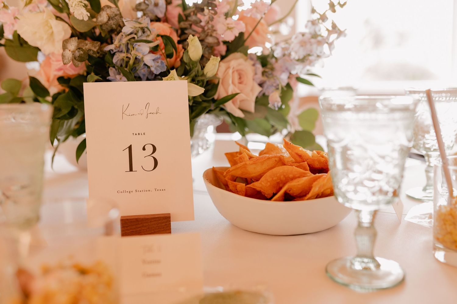 Close up wedding detail photo of centerpieces and table numbers during wedding cocktail houe