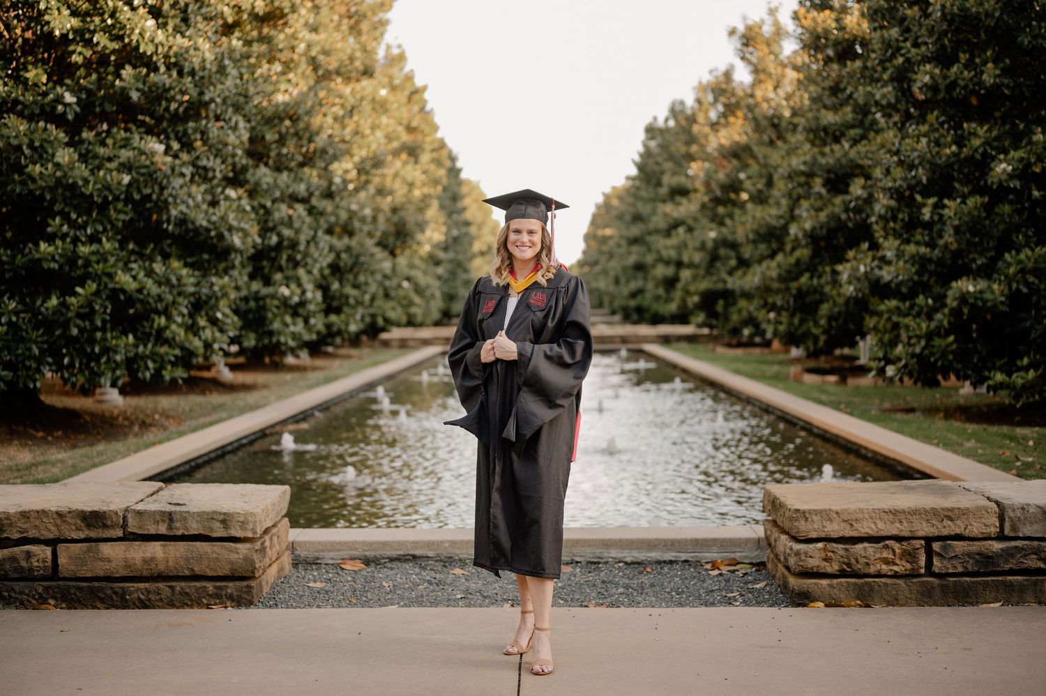 College senior girl posing at University of Texas at Dallas for a fall senior photo session