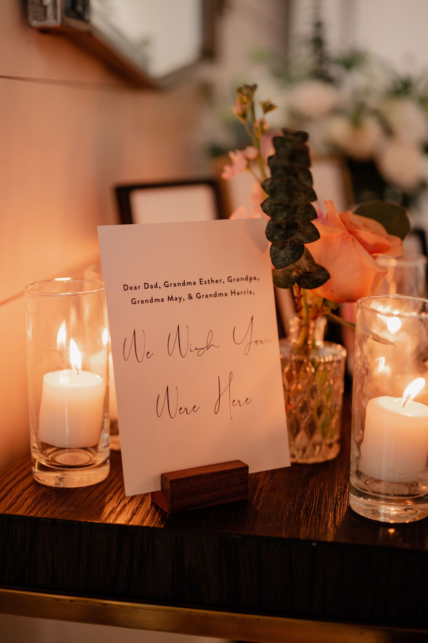 Illuminated white candles with elegant name cards create a romantic ambiance at an evening event setting.