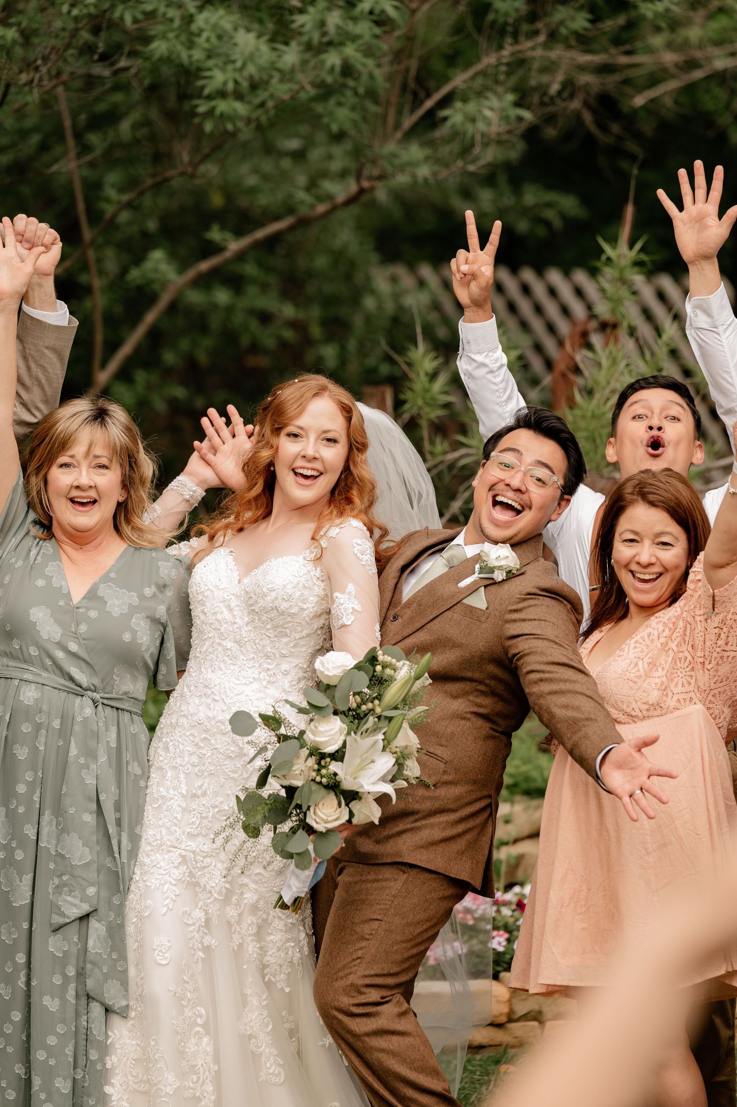 Close up photo of a bride & groom with their extended families celebrating after the ceremony and during family portraits