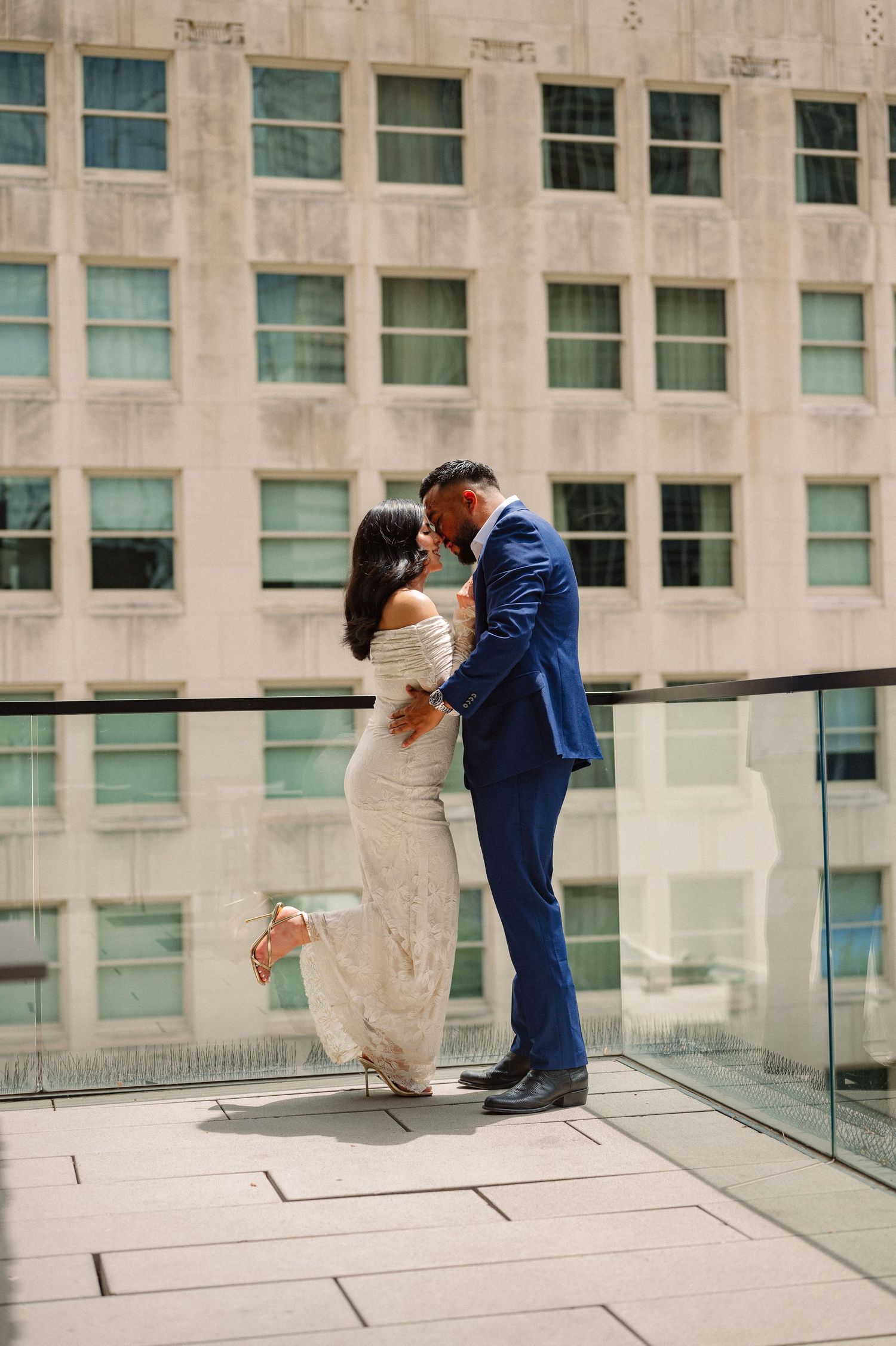 Romantic engagement session of couple at a rooftop bar in downtown Dallas, Texas
