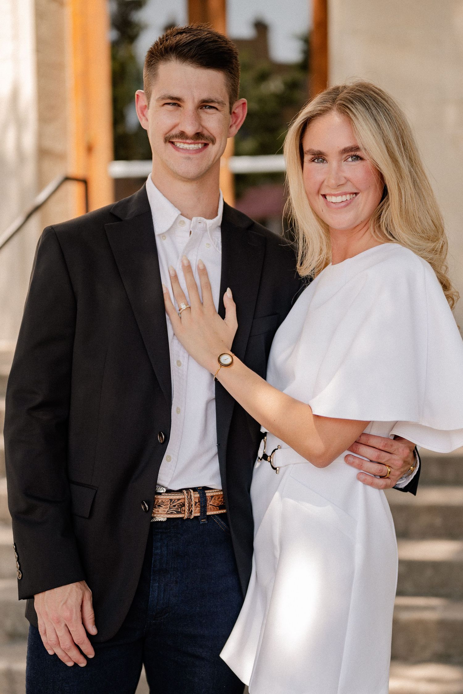 Married couple embracing outside of downtown Rockwall courthouse during elopement wedding photo session