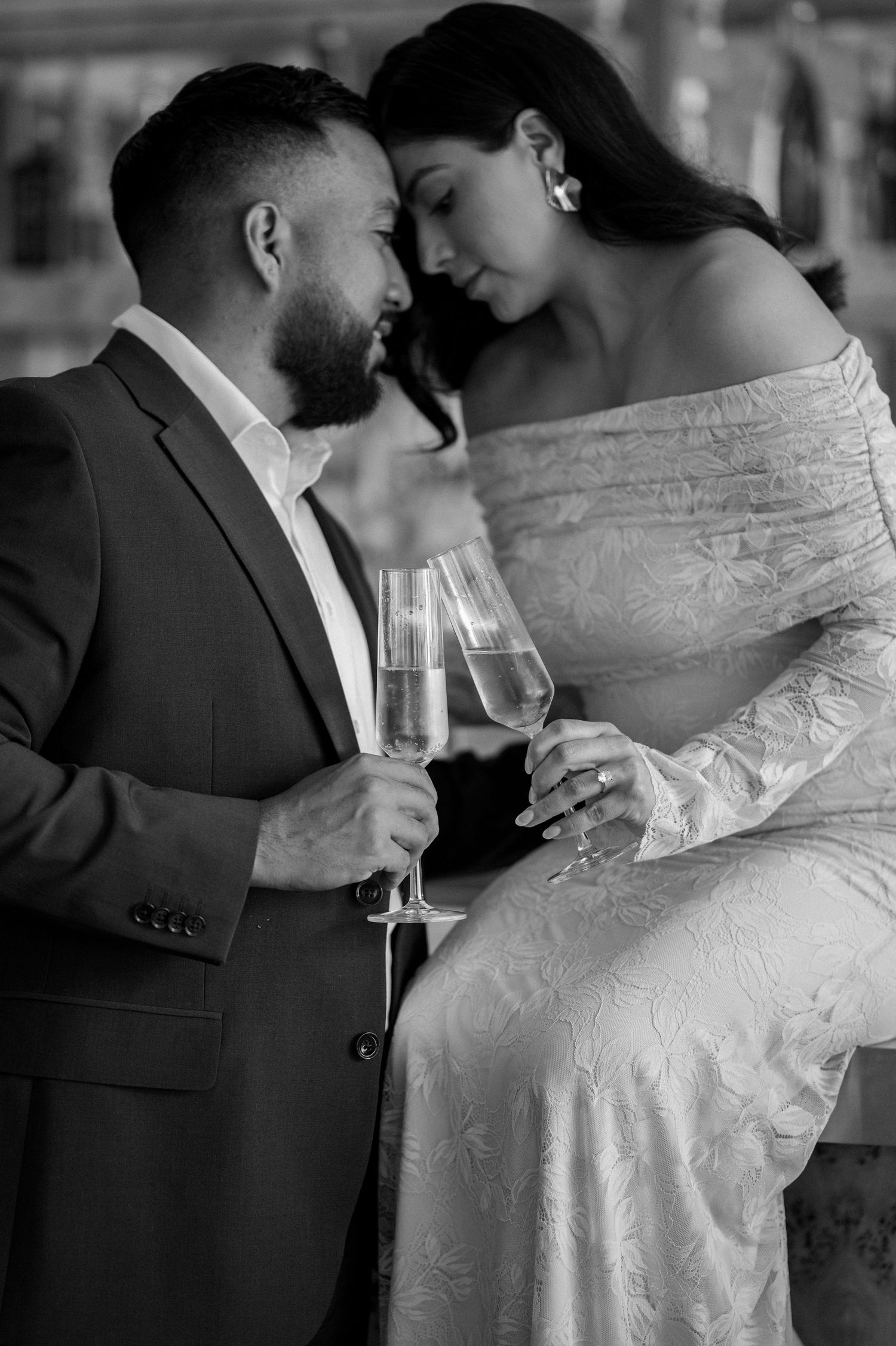 Black and white image of Couple intimately embracing during engagement session at a rooftop venue in Downtown Dallas