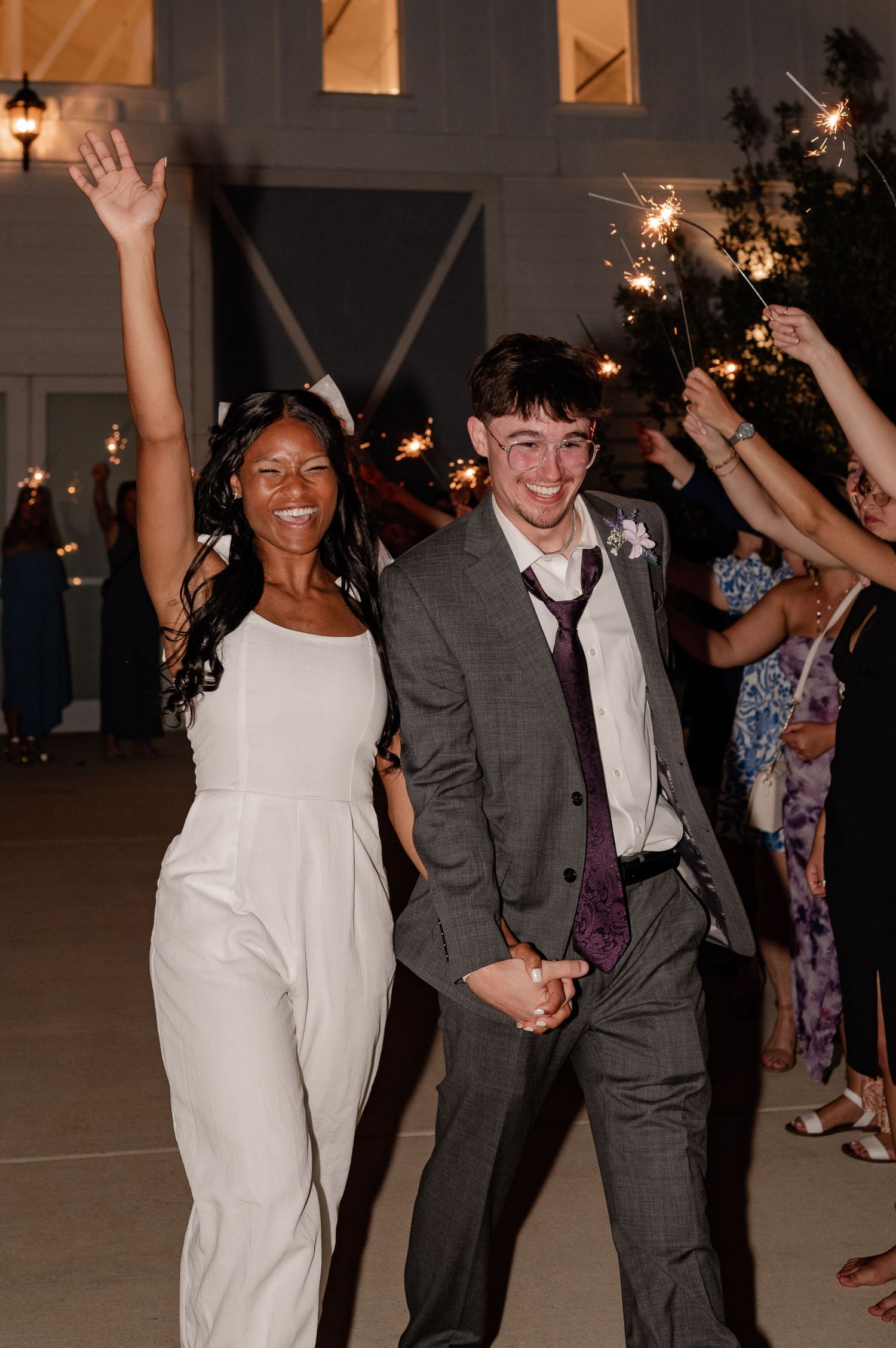 Joyful candid wedding reception sparkler send off of married couple in Princeton, Texas