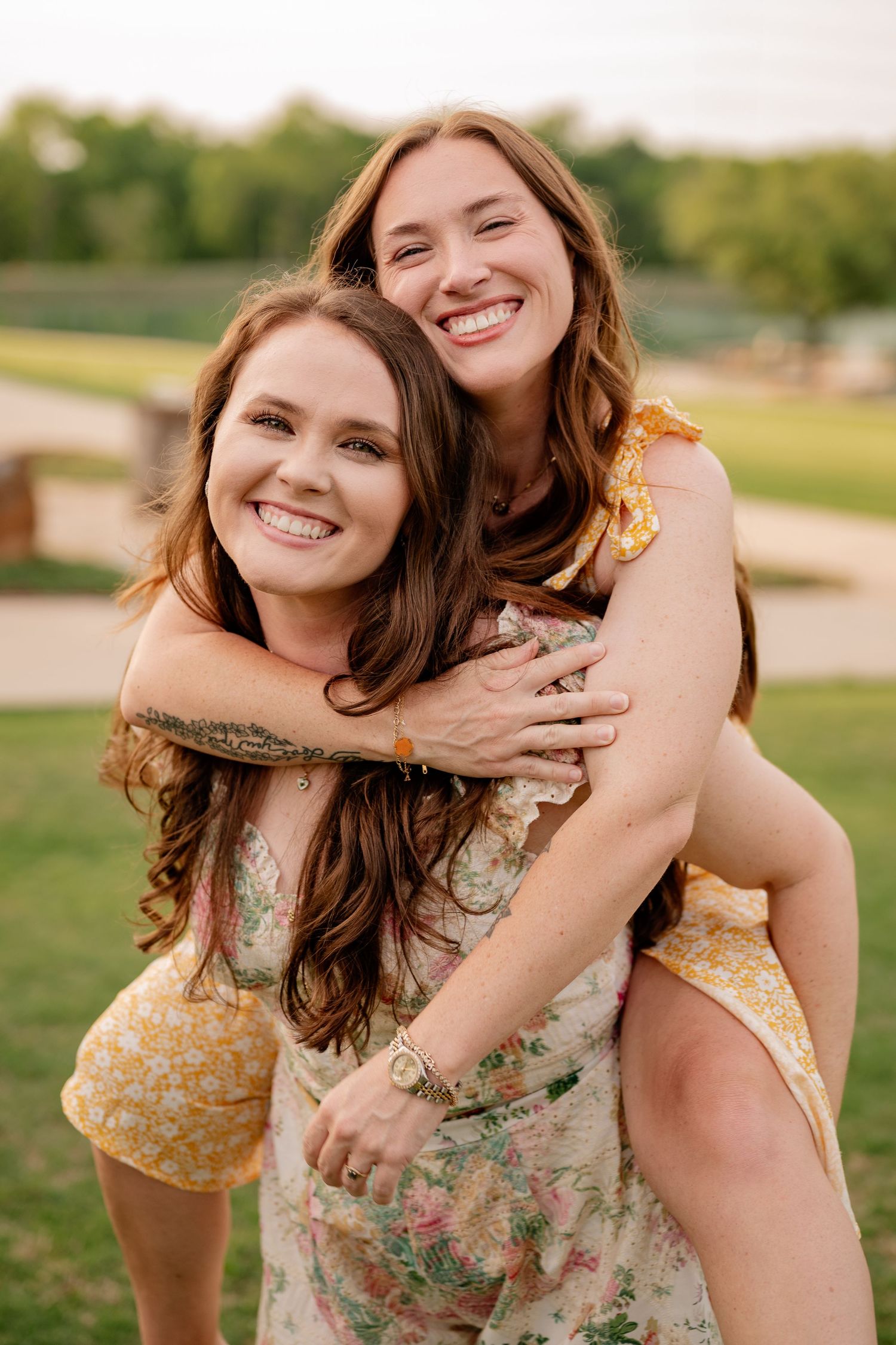 Joyful portrait of two sisters candidly during a spring family photo session in Rockwall, TX.