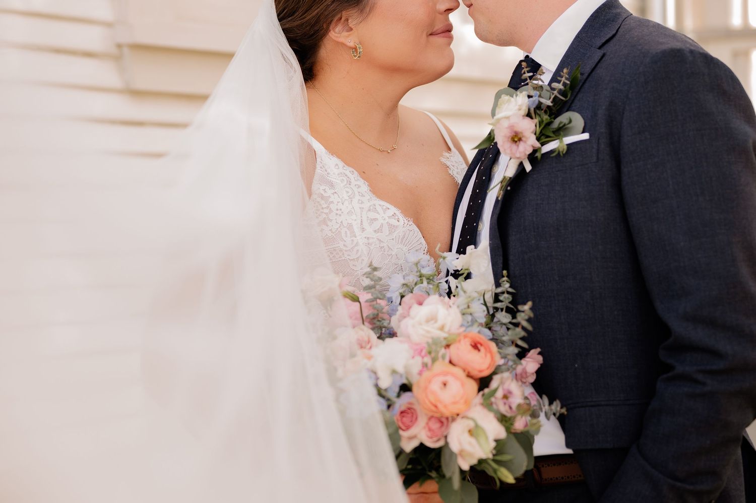 Intimate wedding portrait with bride holding bouquet and new husband outside Bishop Arts venue in Dallas, Texas