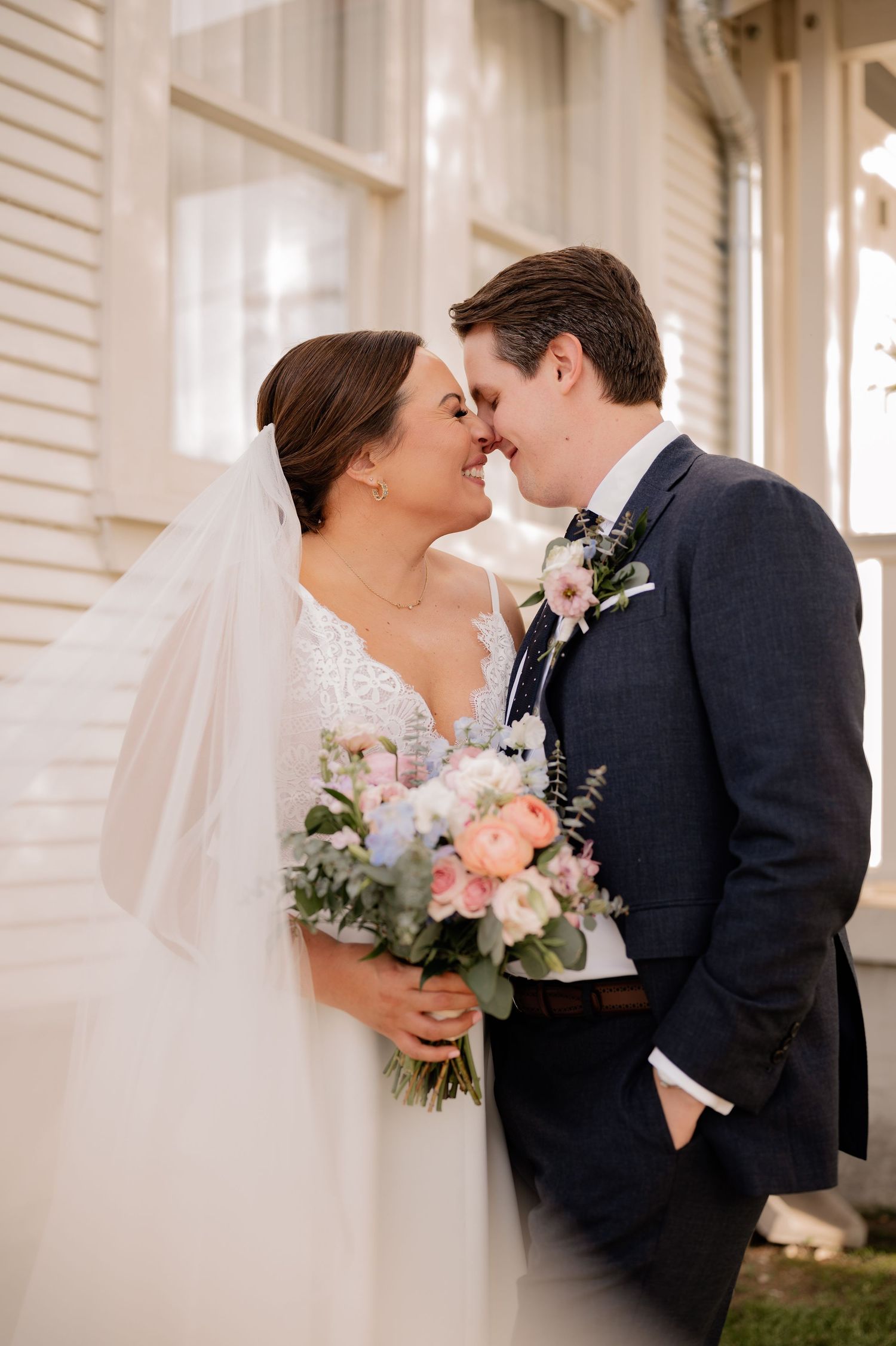 A romantic moment between bride and groom  during wedding couple portraits outside of wedding venue in Bishop Arts, Dallas, Texas
