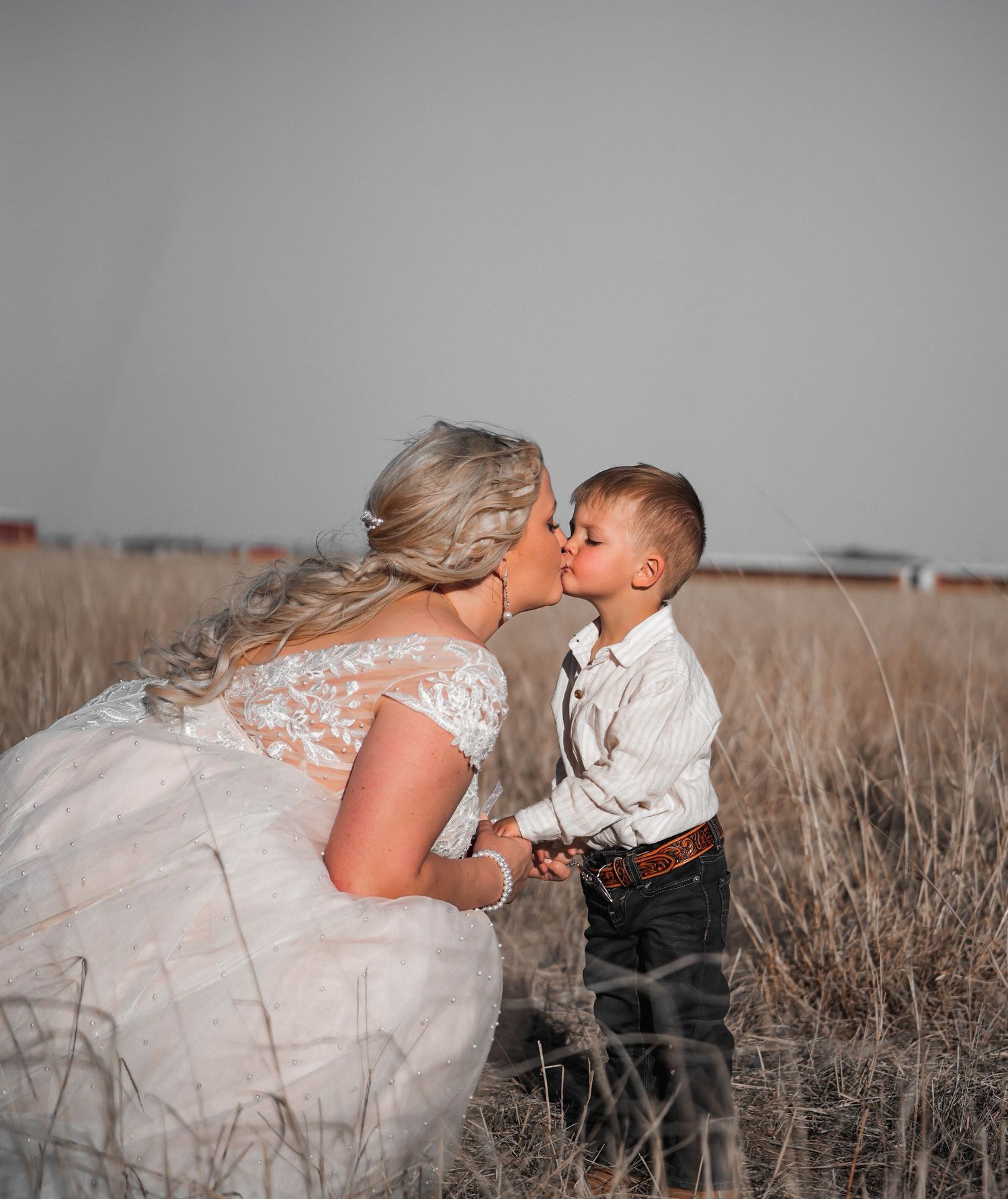 A series of intimate wedding portraits taken in a rustic field with soft lighting.