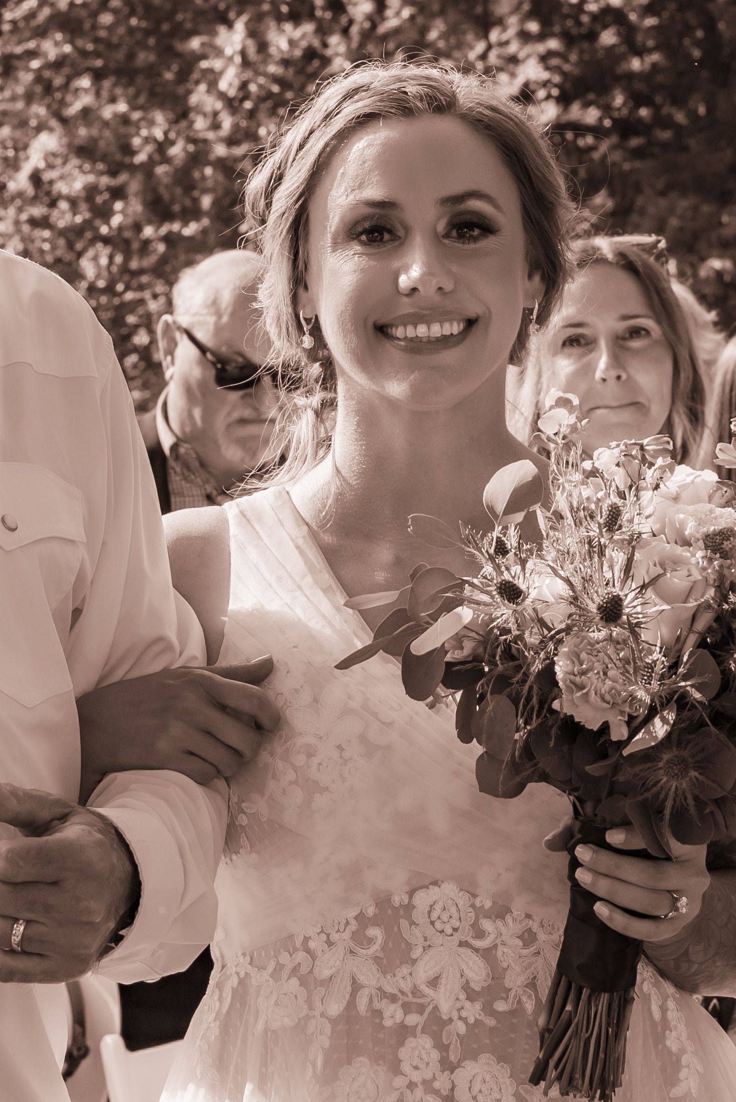 Black and white wedding photos showing joyful moments with floral bouquets.