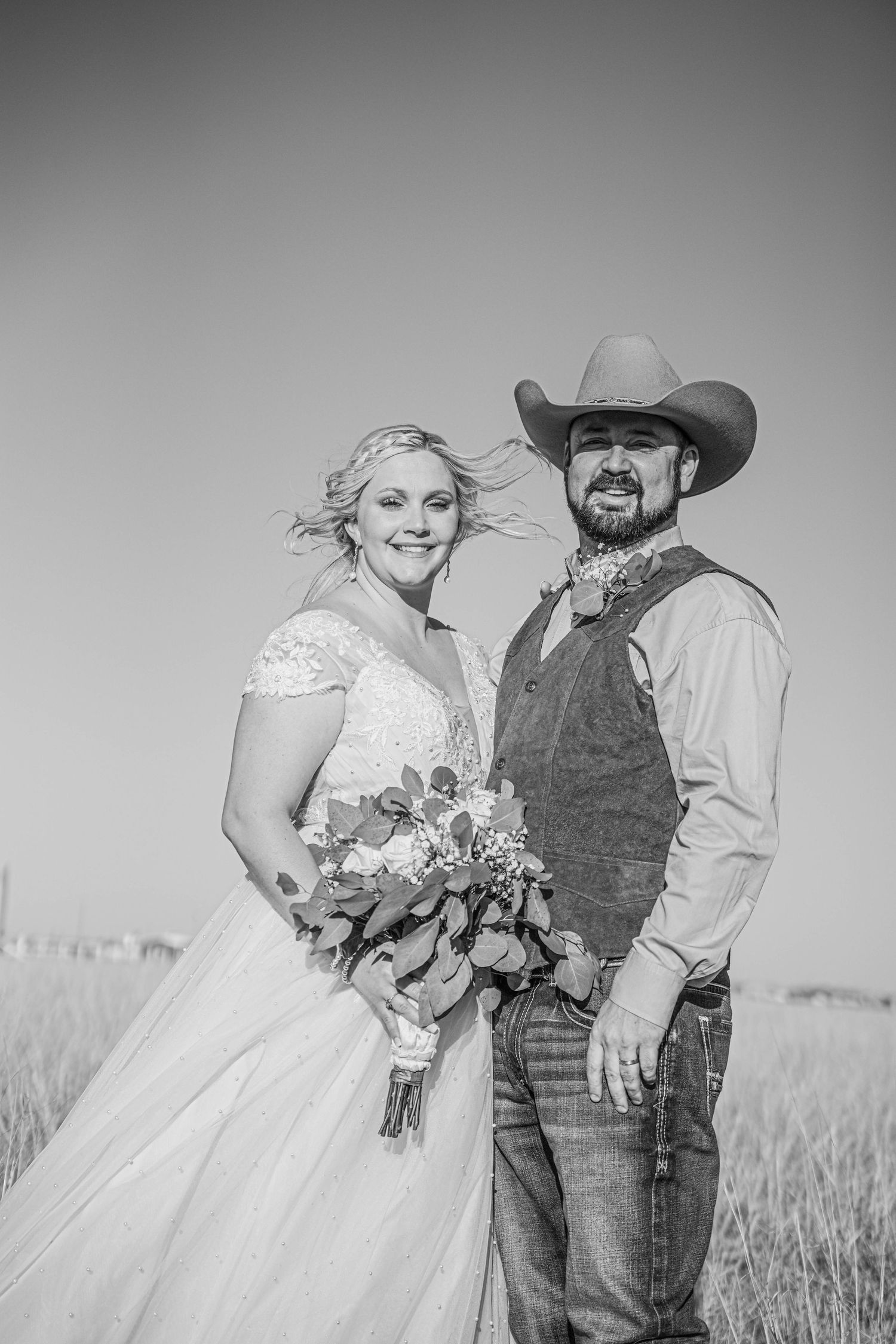 A country-style wedding photo series featuring a couple in casual western attire against a wheat field.