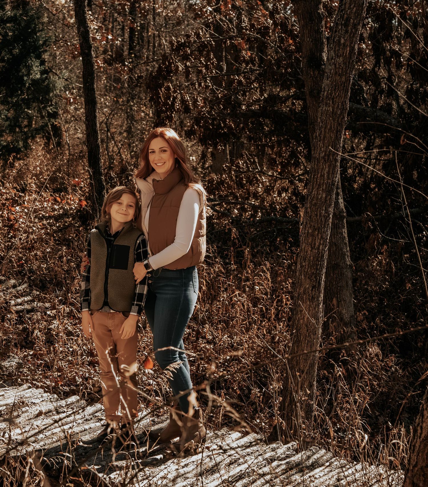 Candid moments captured in a sunlit autumn forest setting.
