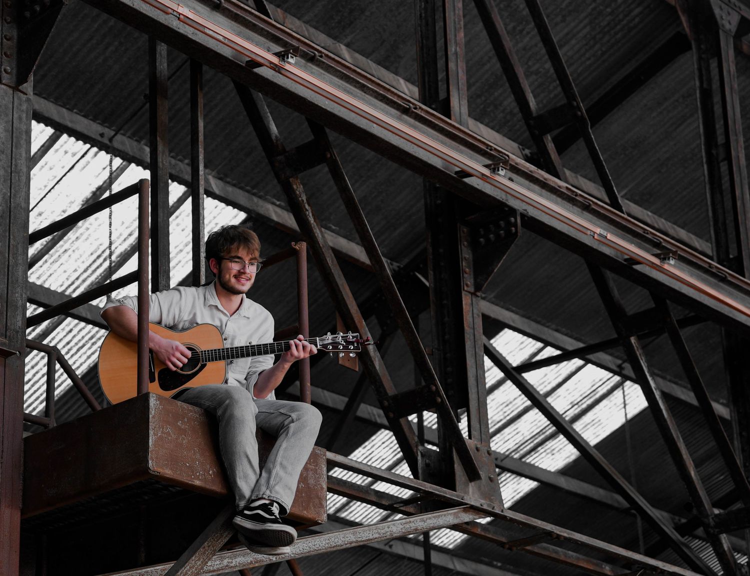 A romantic photo series captured in an industrial warehouse setting with dramatic lighting.
