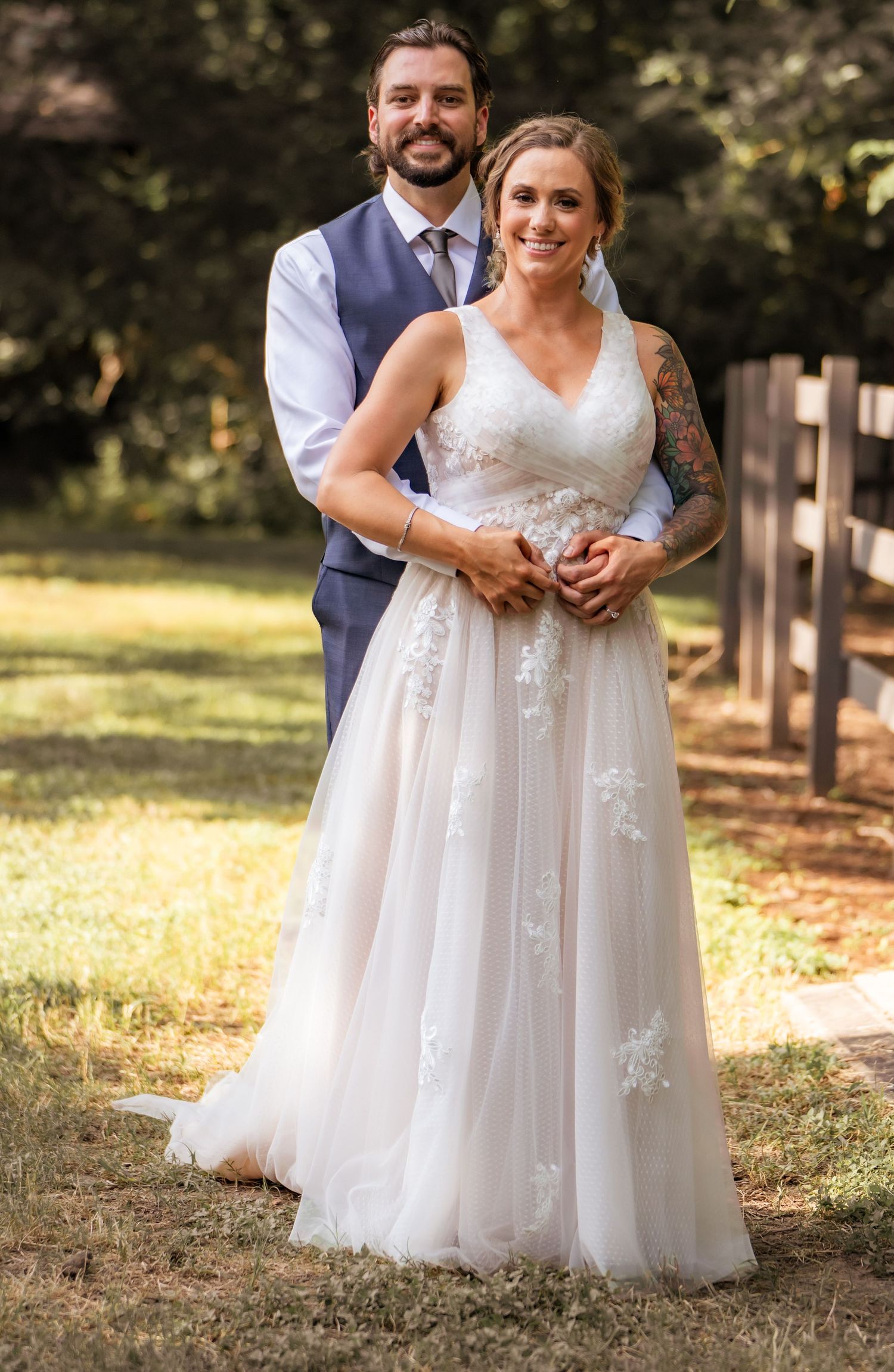 A romantic wedding photo shoot in a park shows close-up details of a white lace wedding dress and suit.