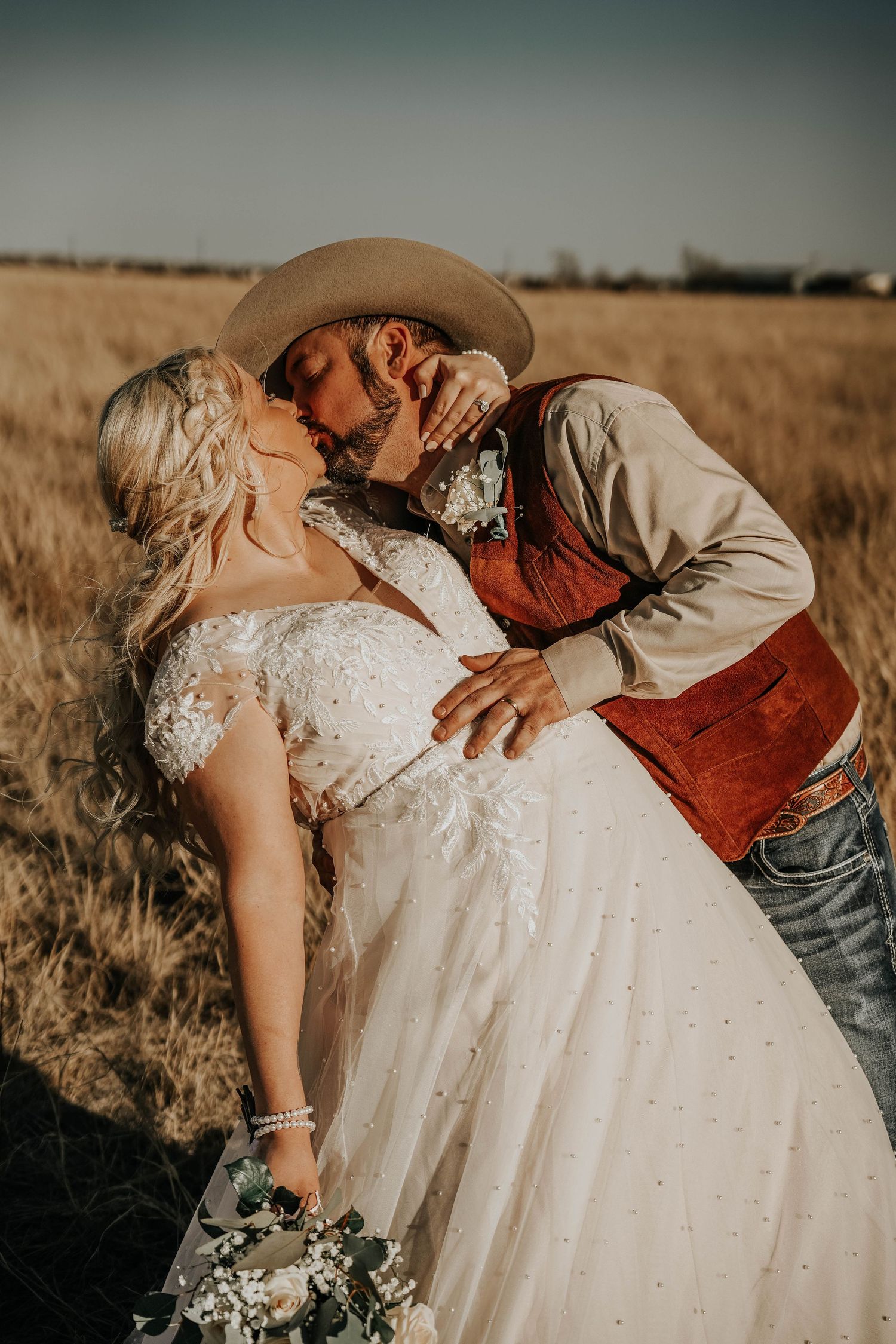A dramatic wedding photoshoot in a golden field with romantic dips and intimate poses.