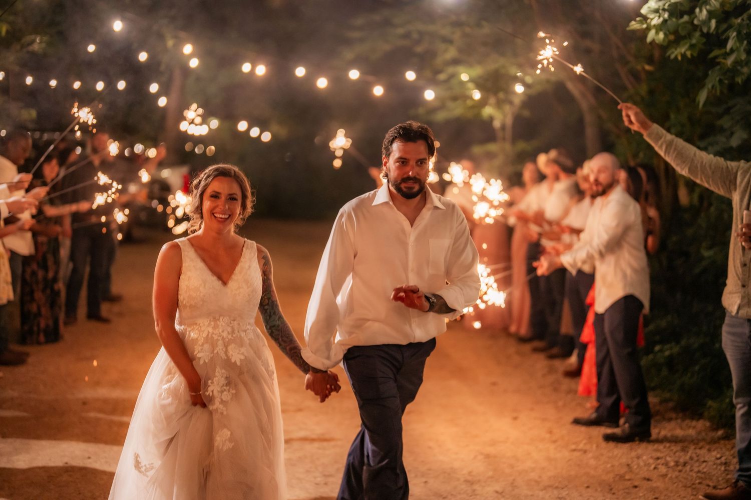 Wedding celebration at night with string lights creating a magical atmosphere.