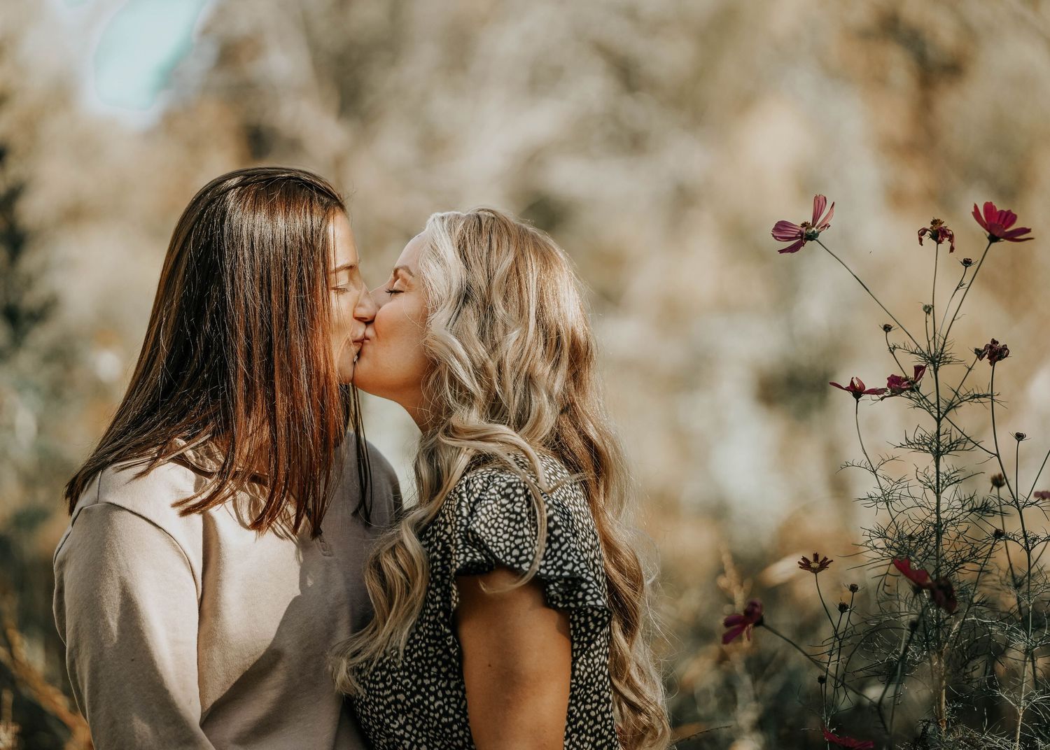 Close-up shots of tender moments between a couple in a natural outdoor setting.