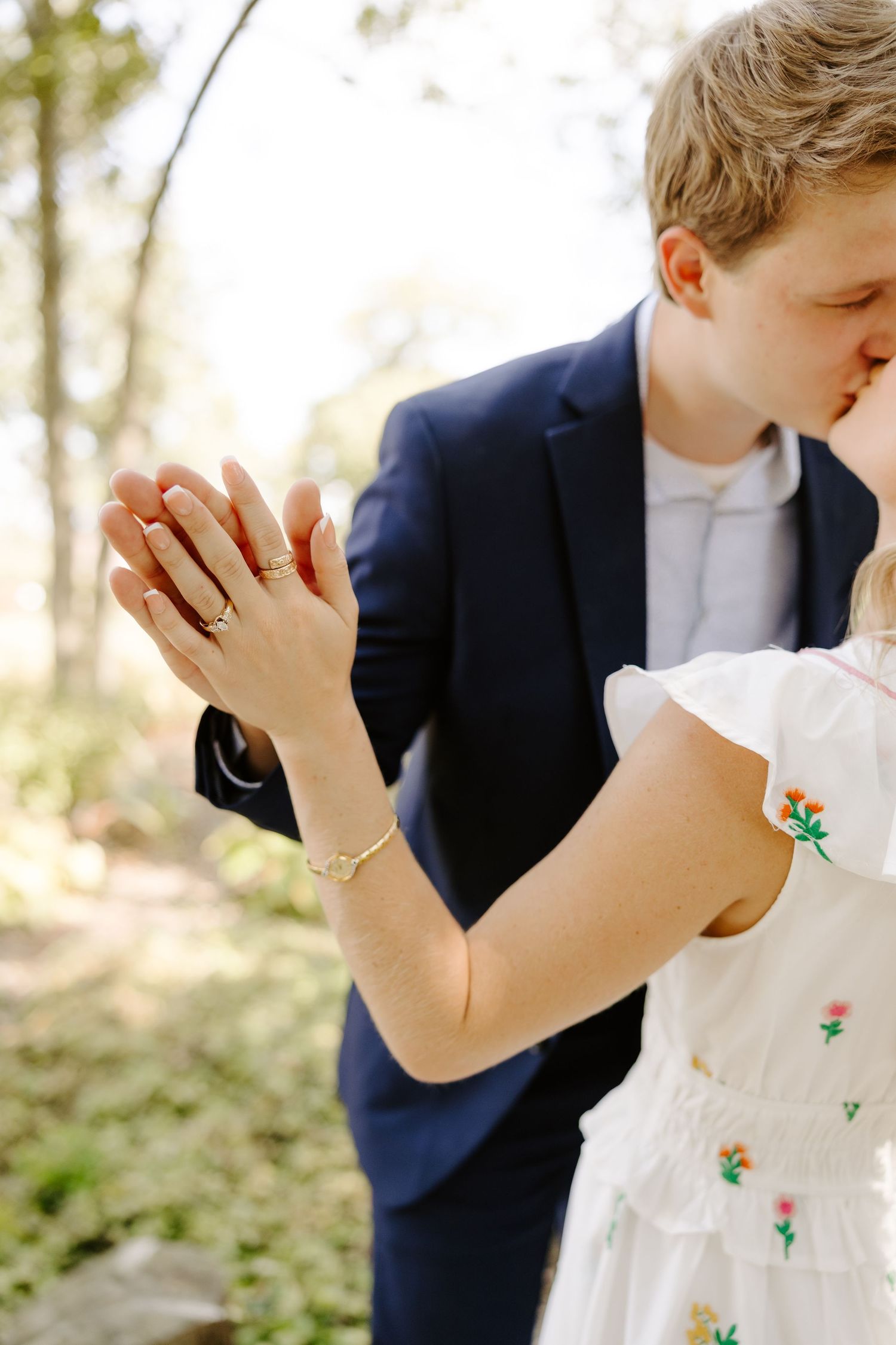 Close-up of hands holding champagne glasses during an outdoor celebration.