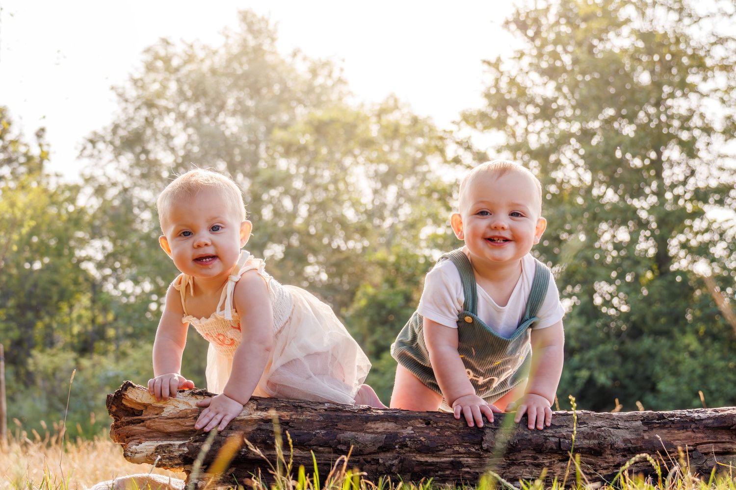 Joyful children play together on a fallen log in a sunlit forest during golden hour, creating playful memories.