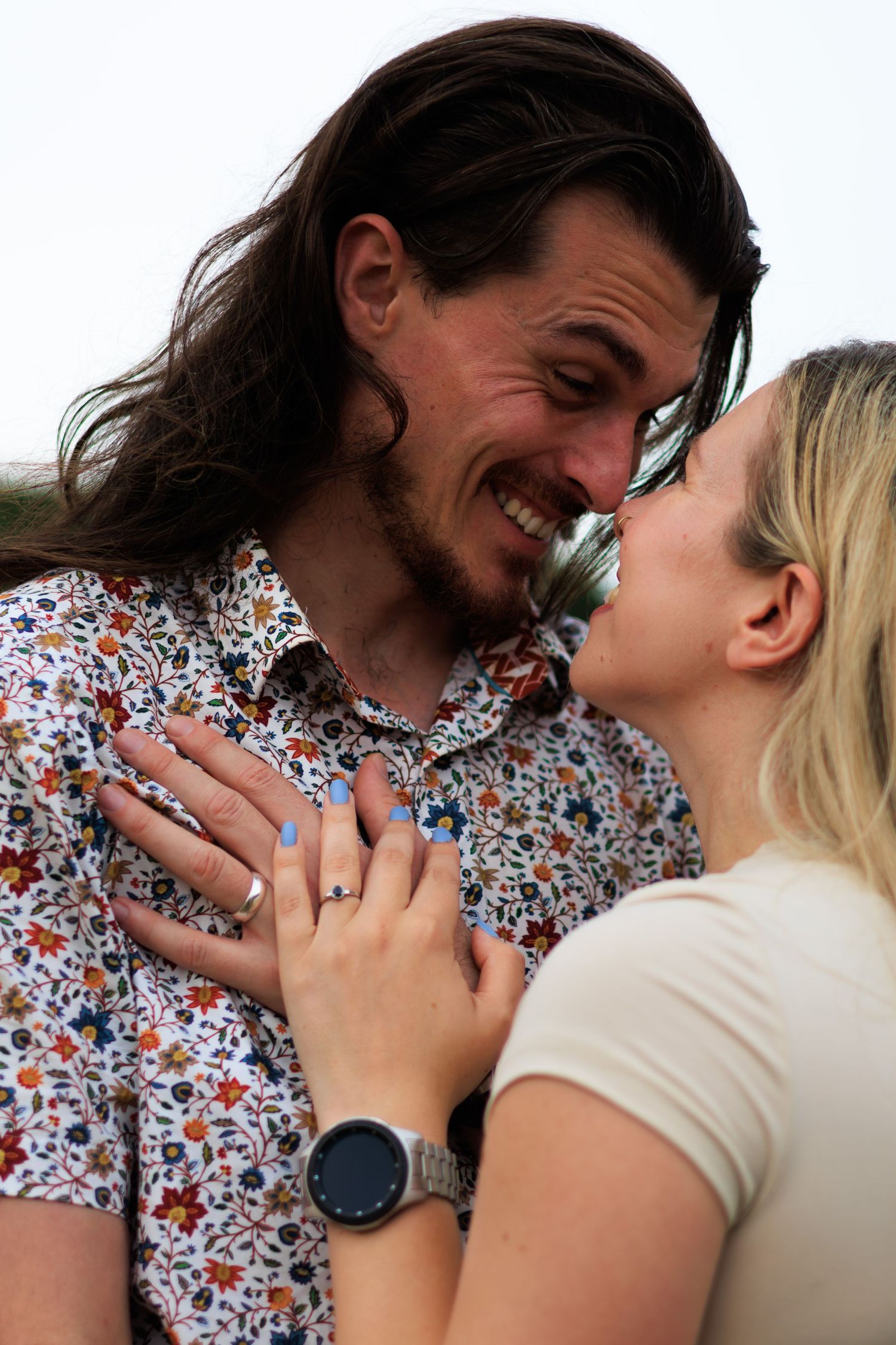 A couple shares a romantic moment in a series of four progressive photos showing them getting closer together.