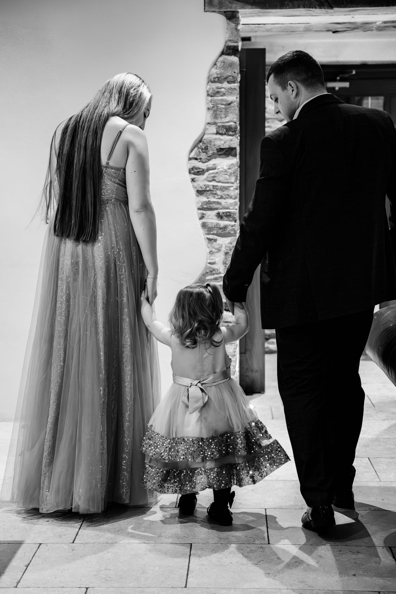 A series of black and white photos showing the feet and lower portions of a bride and groom standing together.