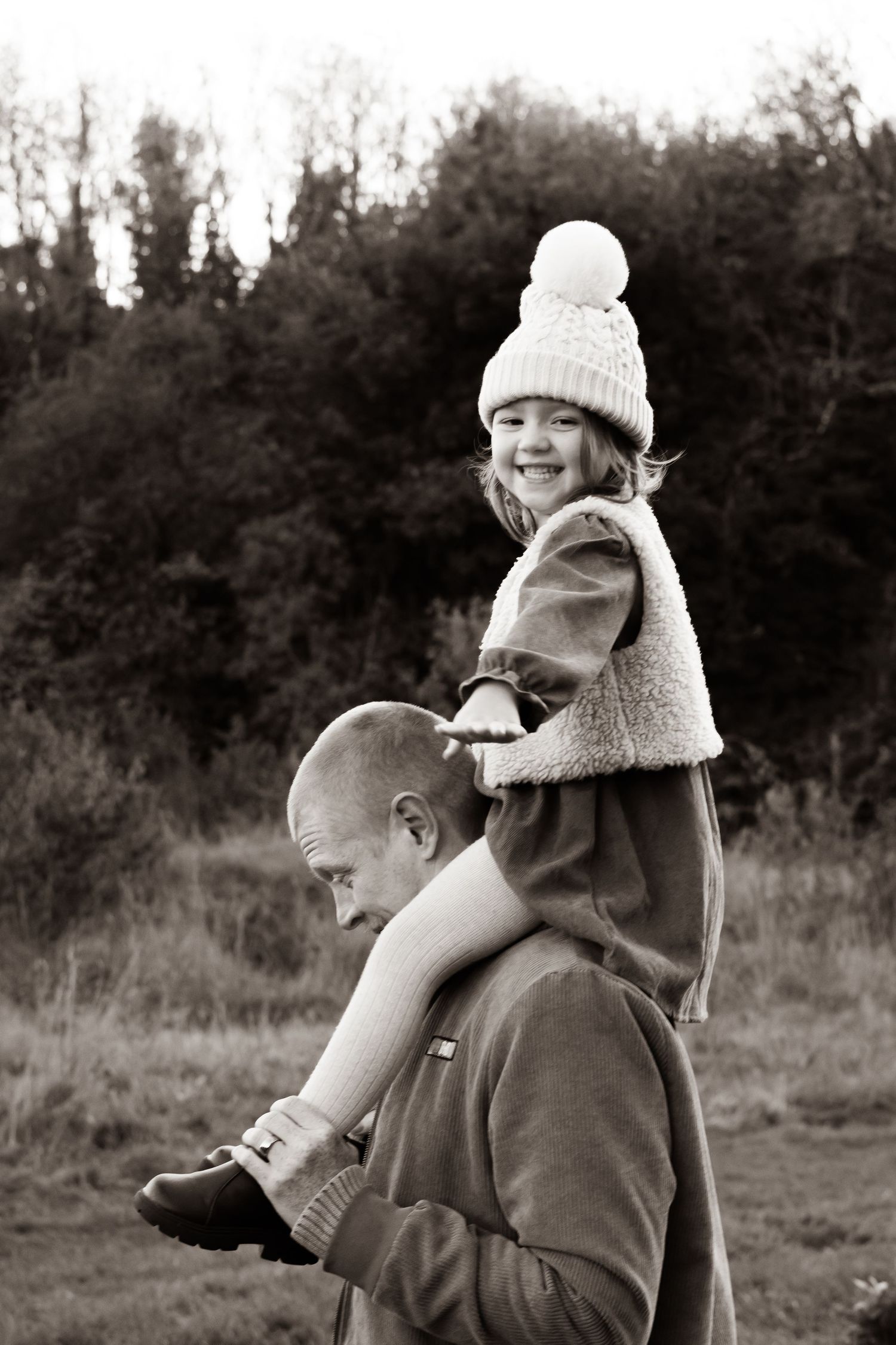 Black and white photo sequence of children playing outdoors in winter hats and coats.