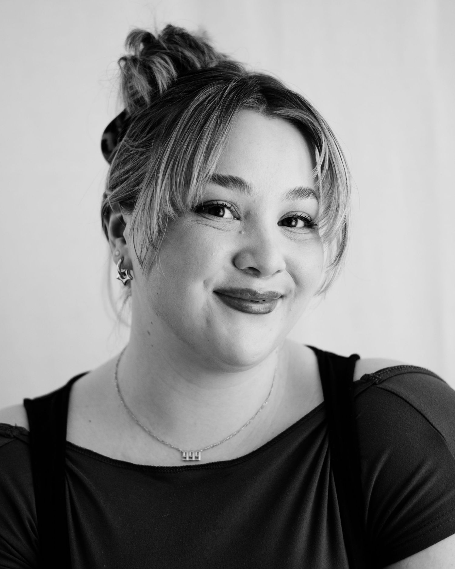 A series of black and white portraits showing expressive poses with dramatic lighting and playful expressions.