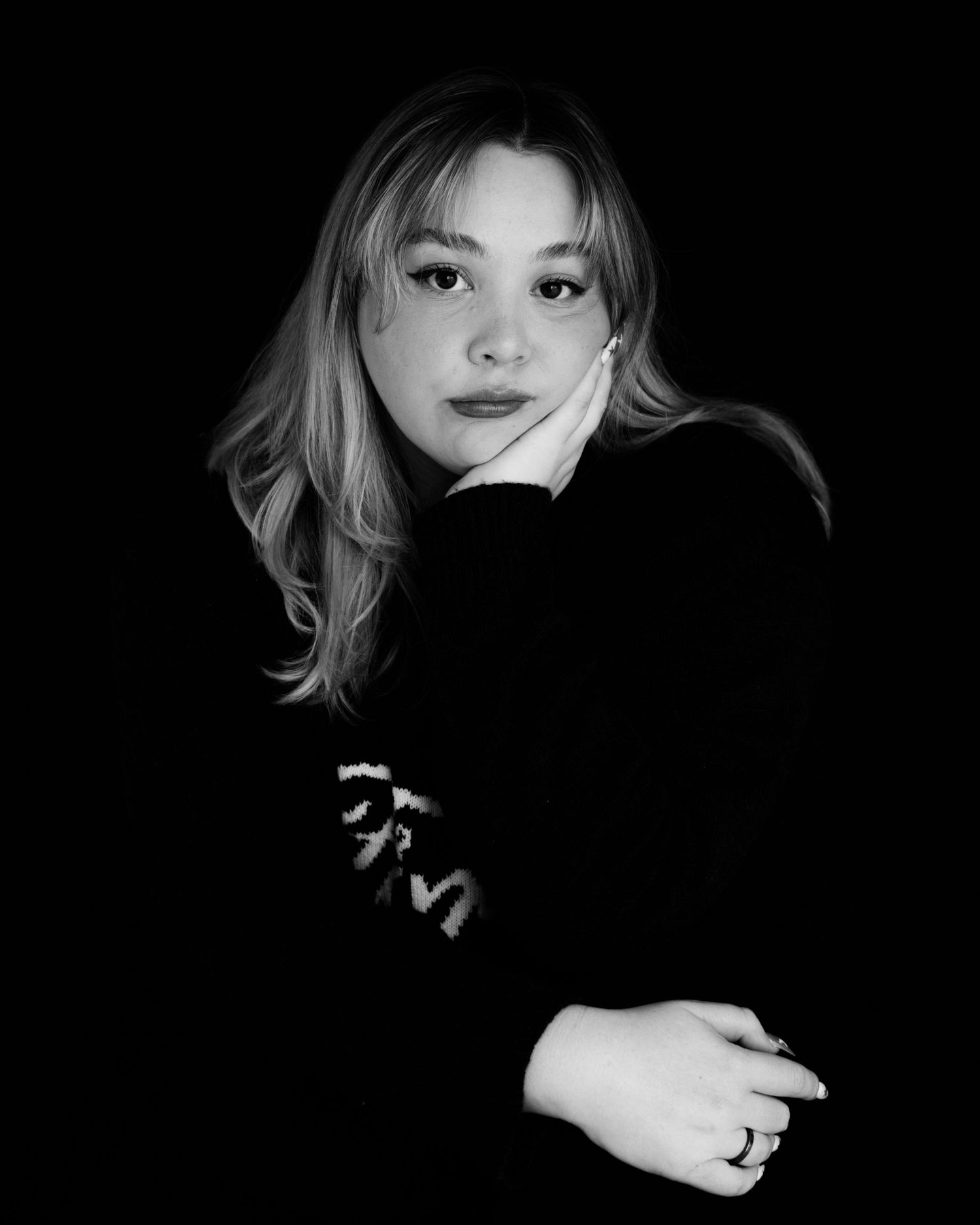 Artistic black and white portrait series showing dramatic lighting and shadows against dark background.