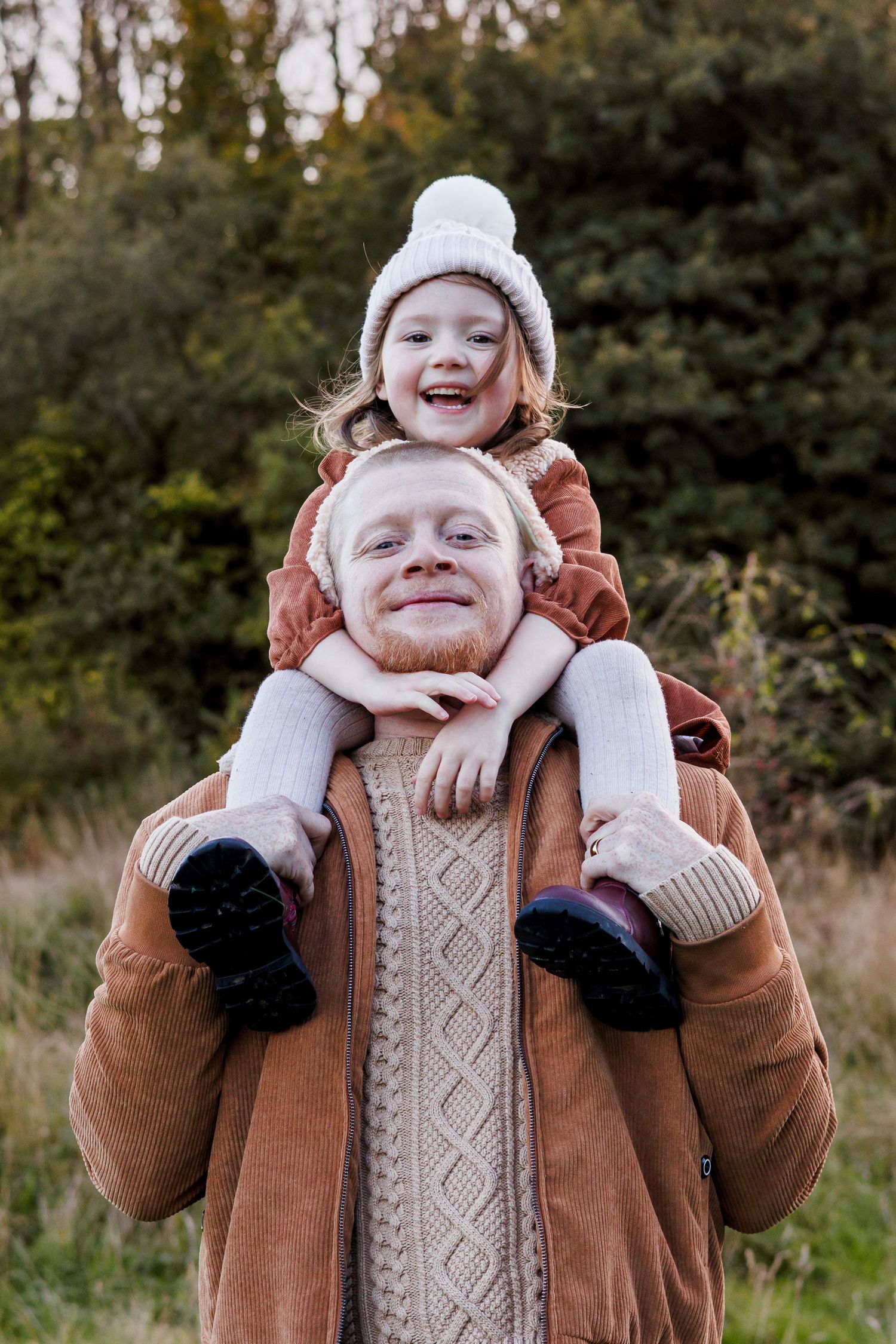 A series of four candid winter portraits showing a person in a brown coat and white knit hat making playful expressions.